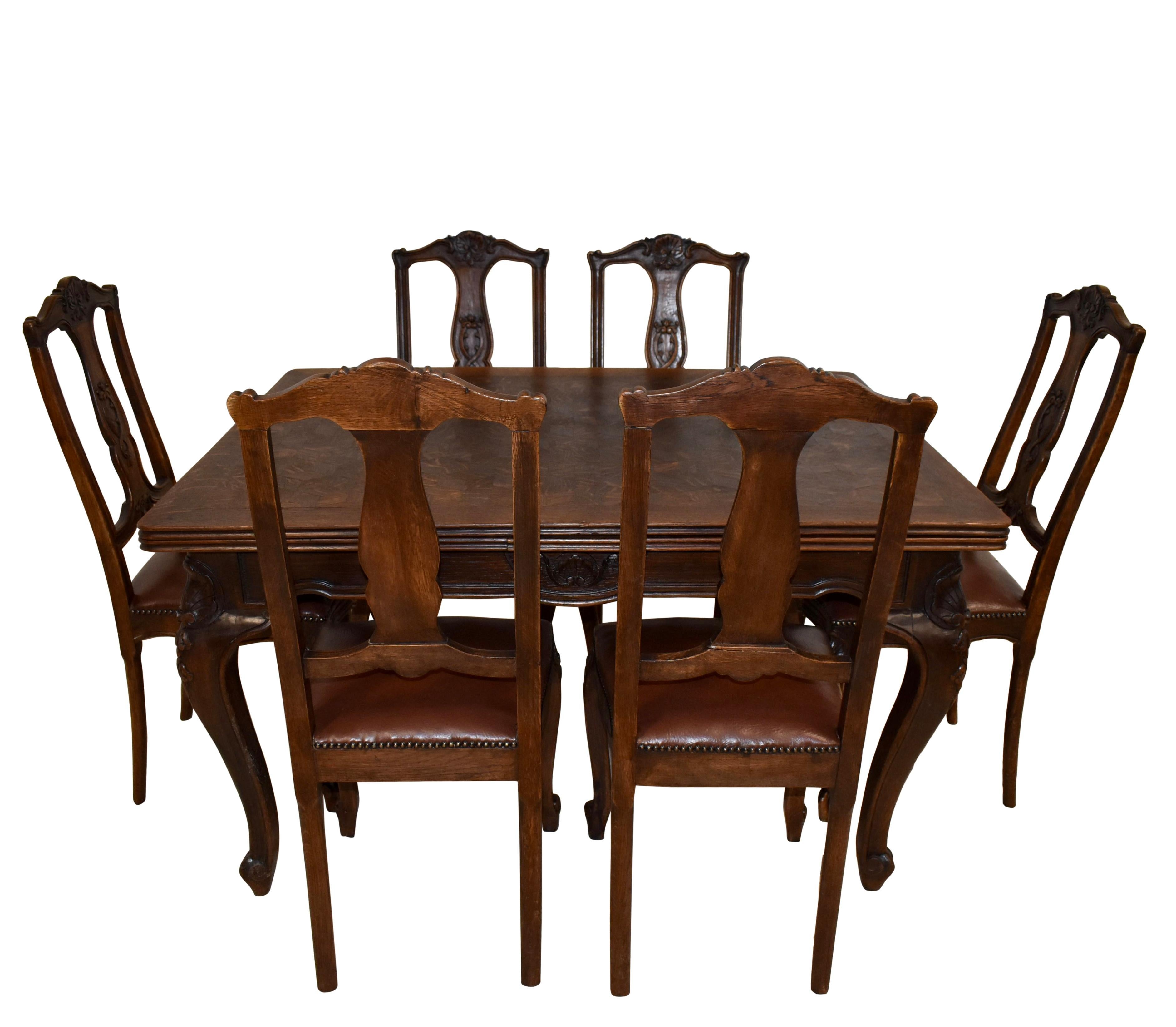 Comprised of a beautiful parquet table and six upholstered chairs, this oak dining set pairs versatility and style to create a stunning set. The table's parquet is crafted from quarter-sawn oak, which produces a distinctive grain that gives the