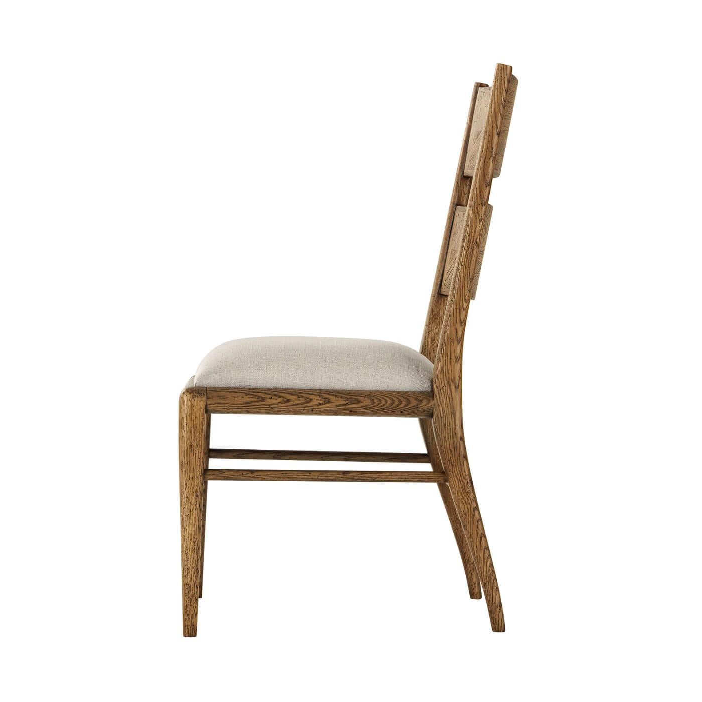 A light oak parquetry dining chair with tapered oak legs. Its upholstered seat is constructed with a top and mid-rail bar joined by stretchers. 
Shown in dawn finish
Shown in Linen-UP5409 Fabric
Dimensions
19.5