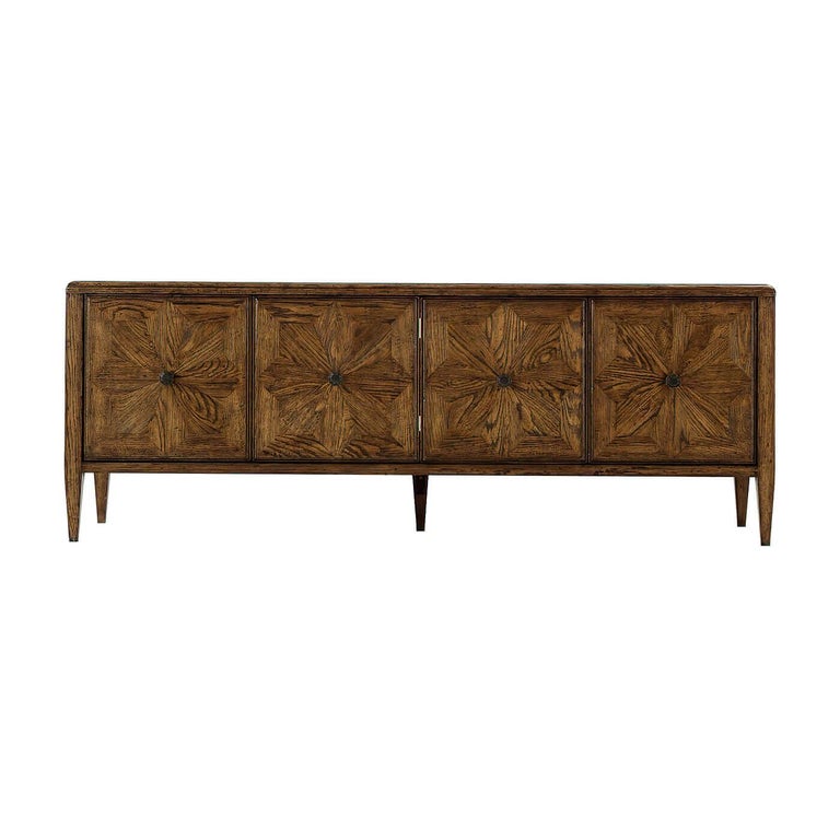 An oak parquetry four-door entertainment media cabinet, perfect to use as a cabinet for additional storage space or an entertainment console. It has oak parquetry doors accented with Verde Bronze finished handles and classically tapered legs.