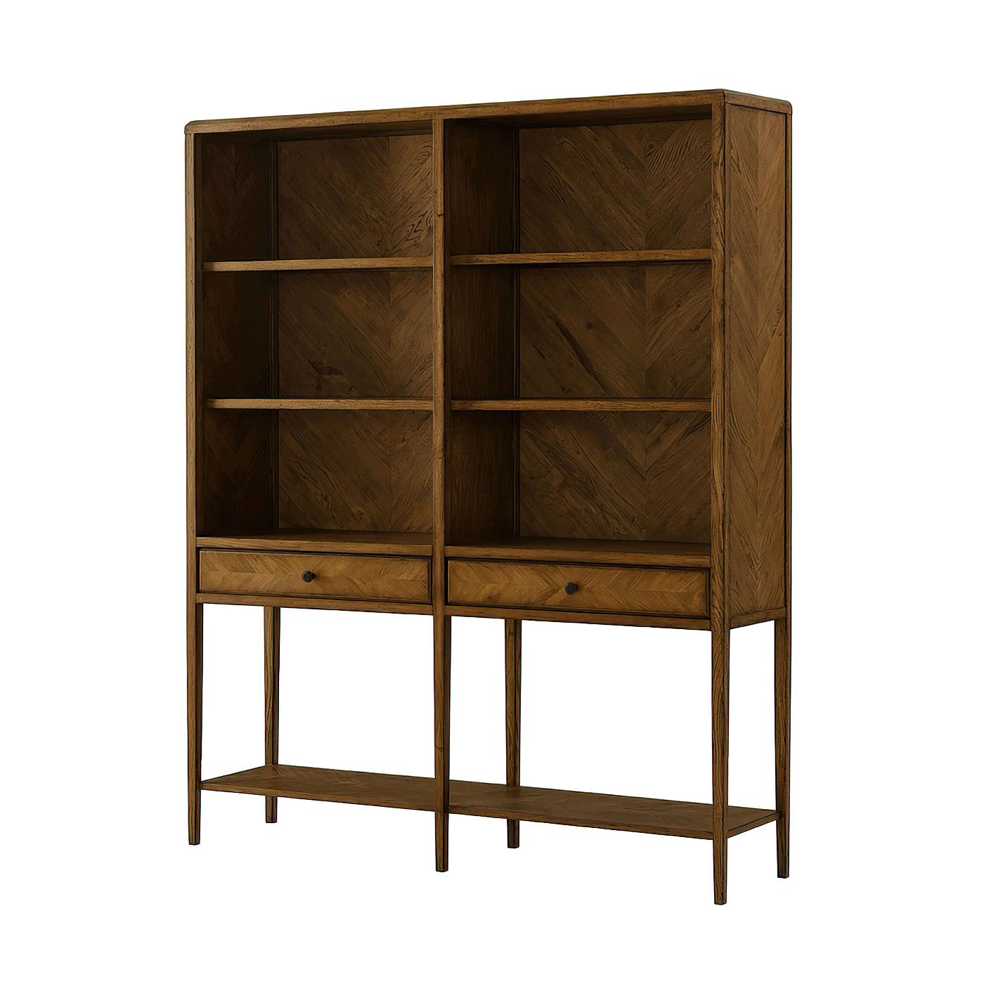 An oak parquetry open bookcase with tapered legs. It has a beautiful herringbone oak parquetry on the back panel and hand-crafted veneered shelves. It has two frieze drawers and Verde Bronze finished handles. 

Shown in Dusk
