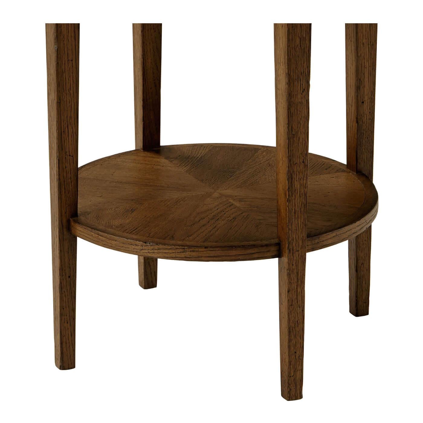 A dark oak parquetry round side table with tapered oak legs. This beautiful round two-tier side table has an arranged radial design on its oak parquetry top and shelf.

Shown in dusk finish
DIMENSIONS
18