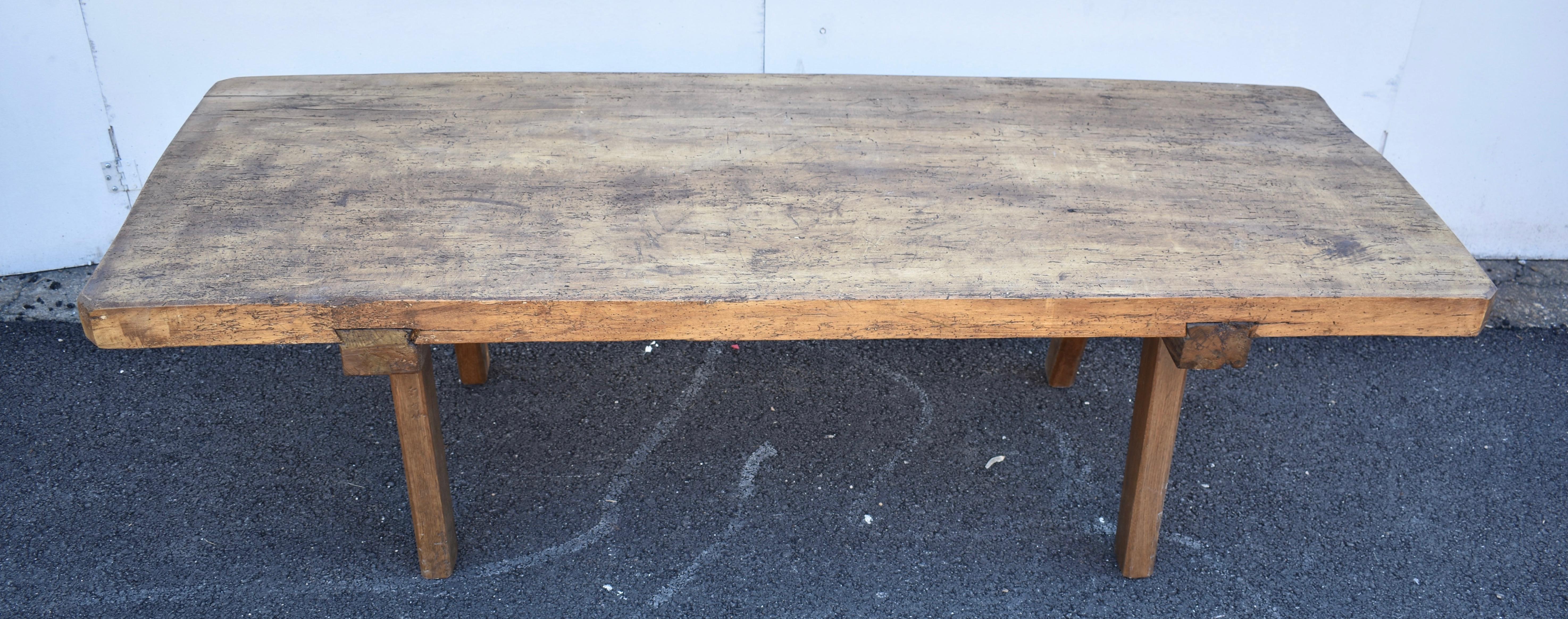 The massive top of this outstanding pig bench is a single slab of oak nearly six feet long and over two feet wide, chamfered at the corners and nearly three inches thick. This one has seen only relatively light use. It is not chopped and gnarled