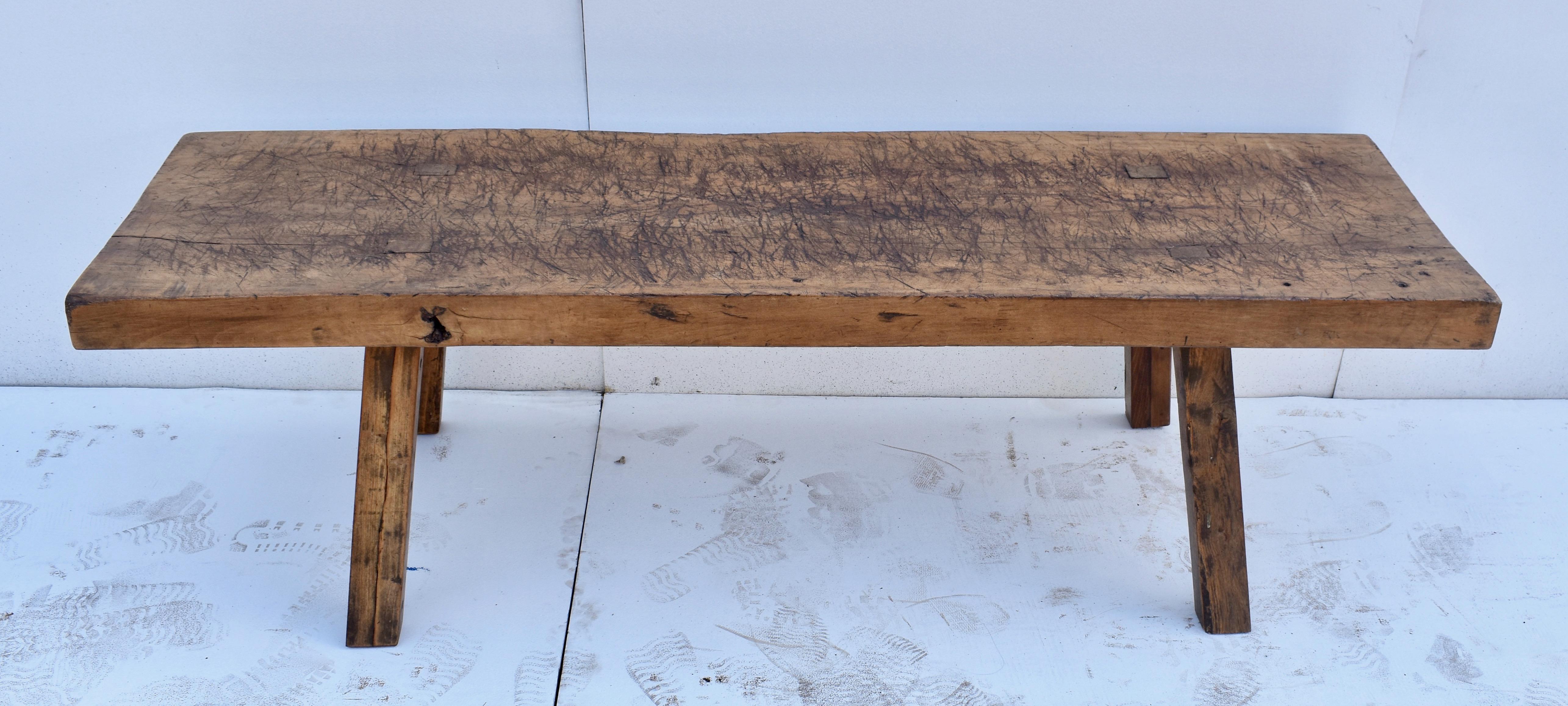 The top of this handsome cut down Pig Bench is a single slab of oak almost 3” thick. It is chopped and sliced and gnarled through decades of purposeful use but is still pretty much flat and allows the table to sit nice and steady. The sturdy legs