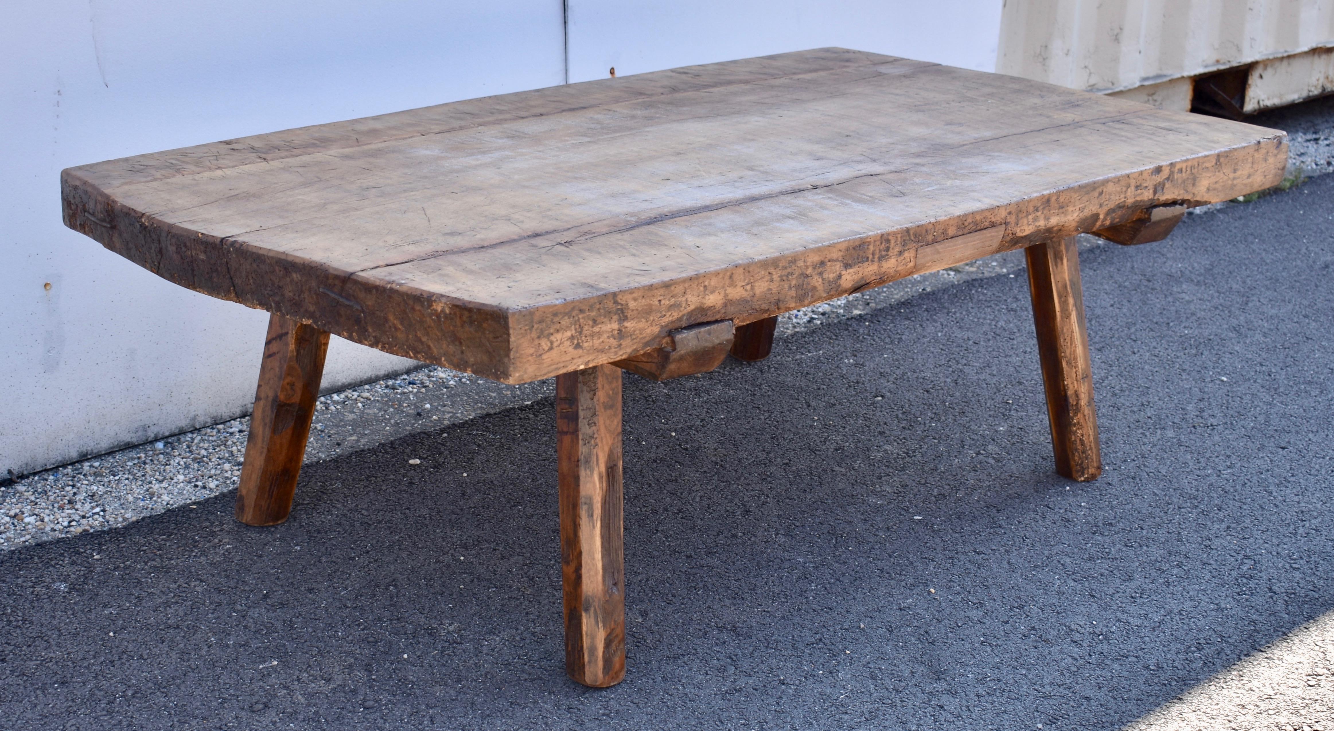 What a fabulously rustic table!  Three planks of oak nearly three inches thick are joined to make this beautiful slab, slightly rounded at one end and bearing all the scrapes and scars of decades of purposeful use.  A modern patch on one bottom edge