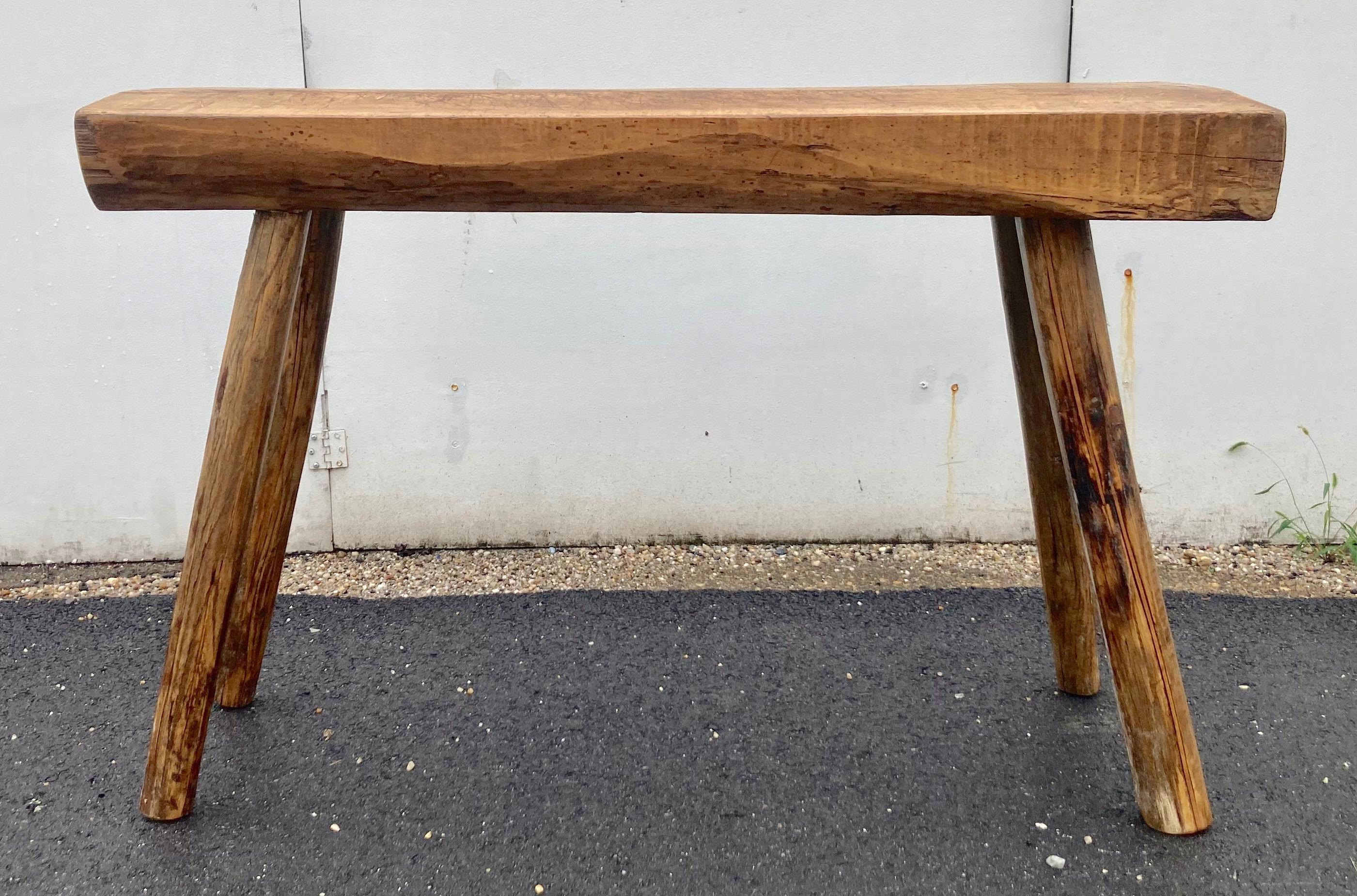 The top of this tough little work table is comprised of a single slab of oak, almost 4” thick and almost 4’ long, sectioned from the trunk with one end still following the line of the tree, the other end squared off.  The surface is covered with the