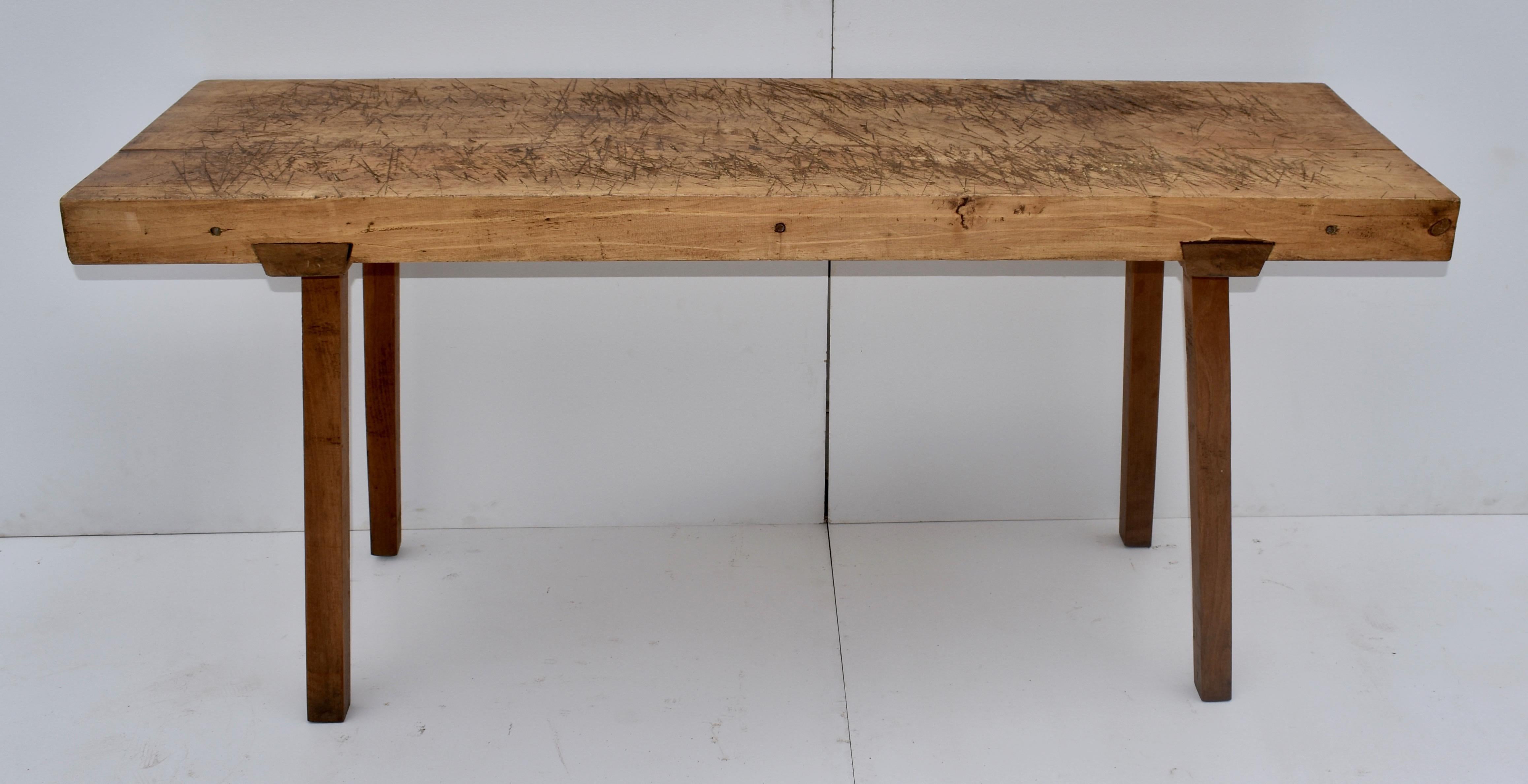 Two massive slabs of oak over 3.5” thick, tightly joined together with three iron bolts passing through the center of the boards, comprise the top of this magnificent pig bench. The dark oak legs, 2” thick, are mortised into sturdy cleats which then