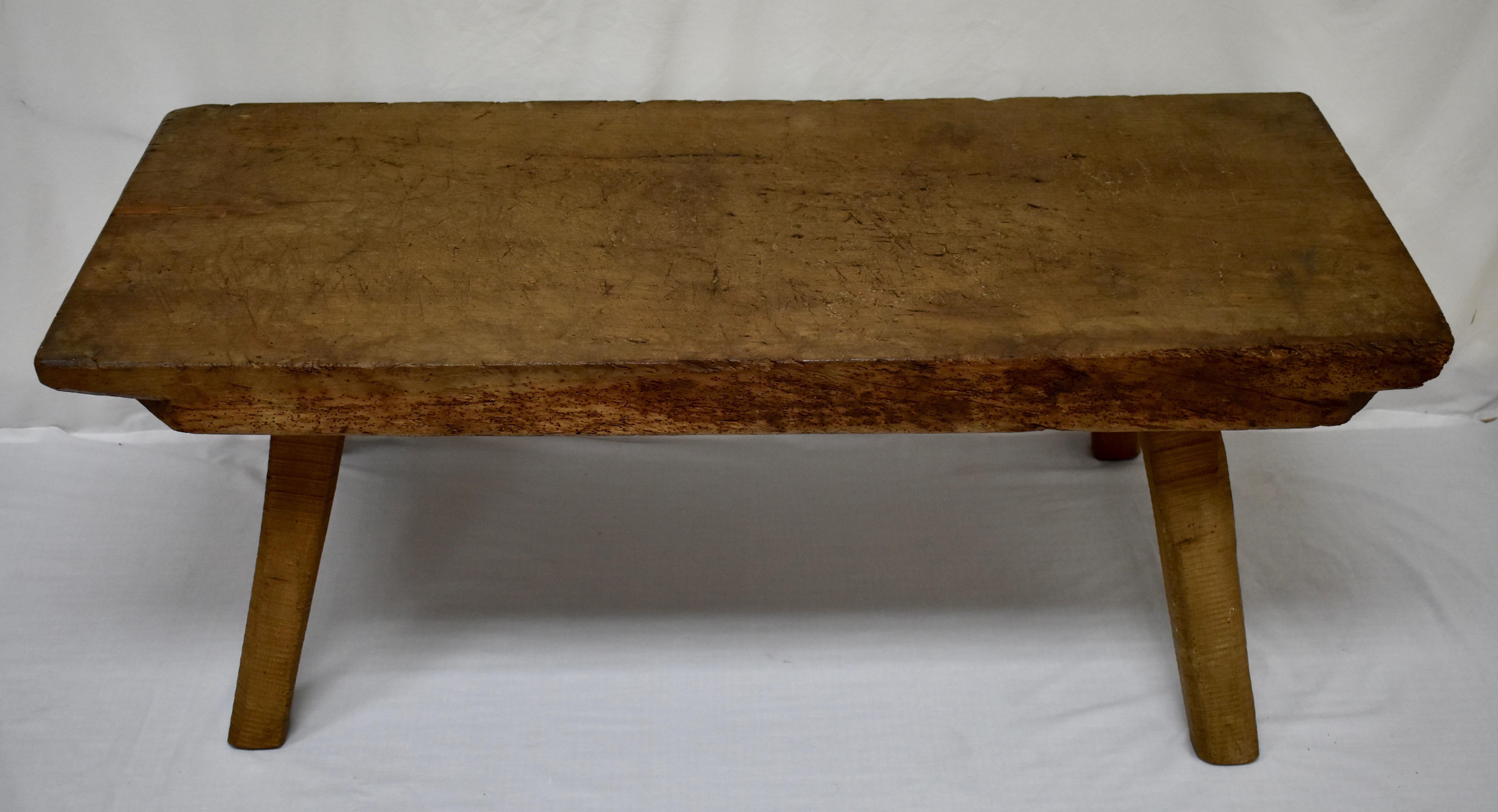 This is another excellent example of an oak pig bench low table. This one stands on four sturdy hand-sawn splayed legs which are mortised into the underside of the top. The top itself is a single slab of oak almost 4” thick, which has the underside