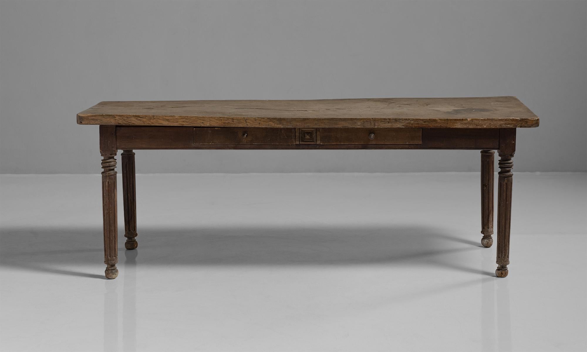 Oak & pine farmhouse table

France circa 1830

Provincial serving table with thick oak slab top over a stained pine base with two frieze drawers.