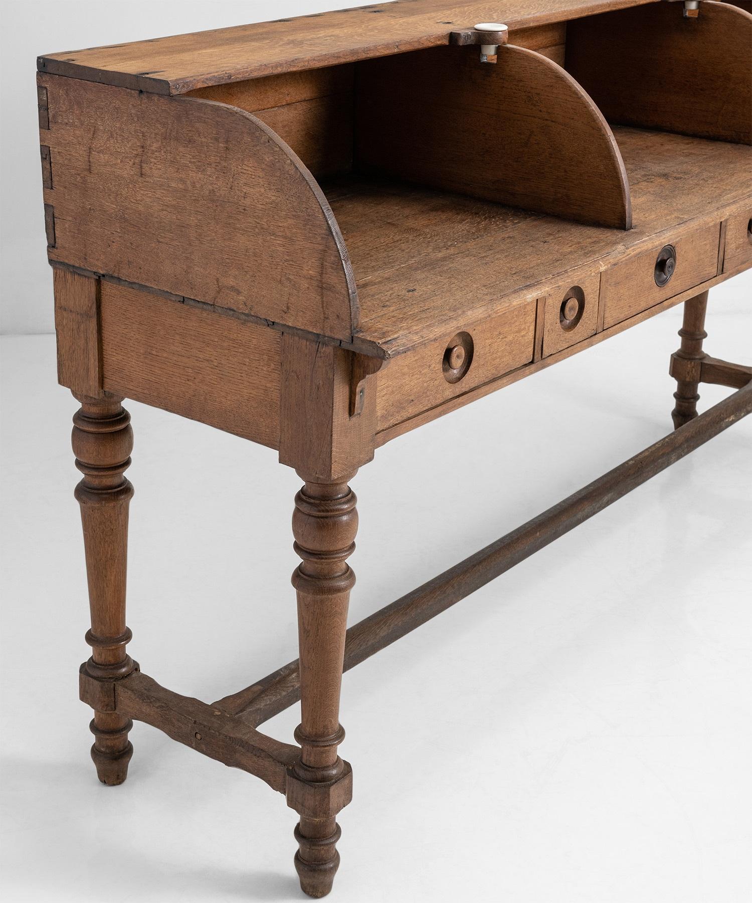 Oak Postal Desk

France Circa 1900

Three seater desk with pull out drawers and ceramic ink wells.

Measures: 77.5”W x 24”D x 44”H x 33.5” surface height.