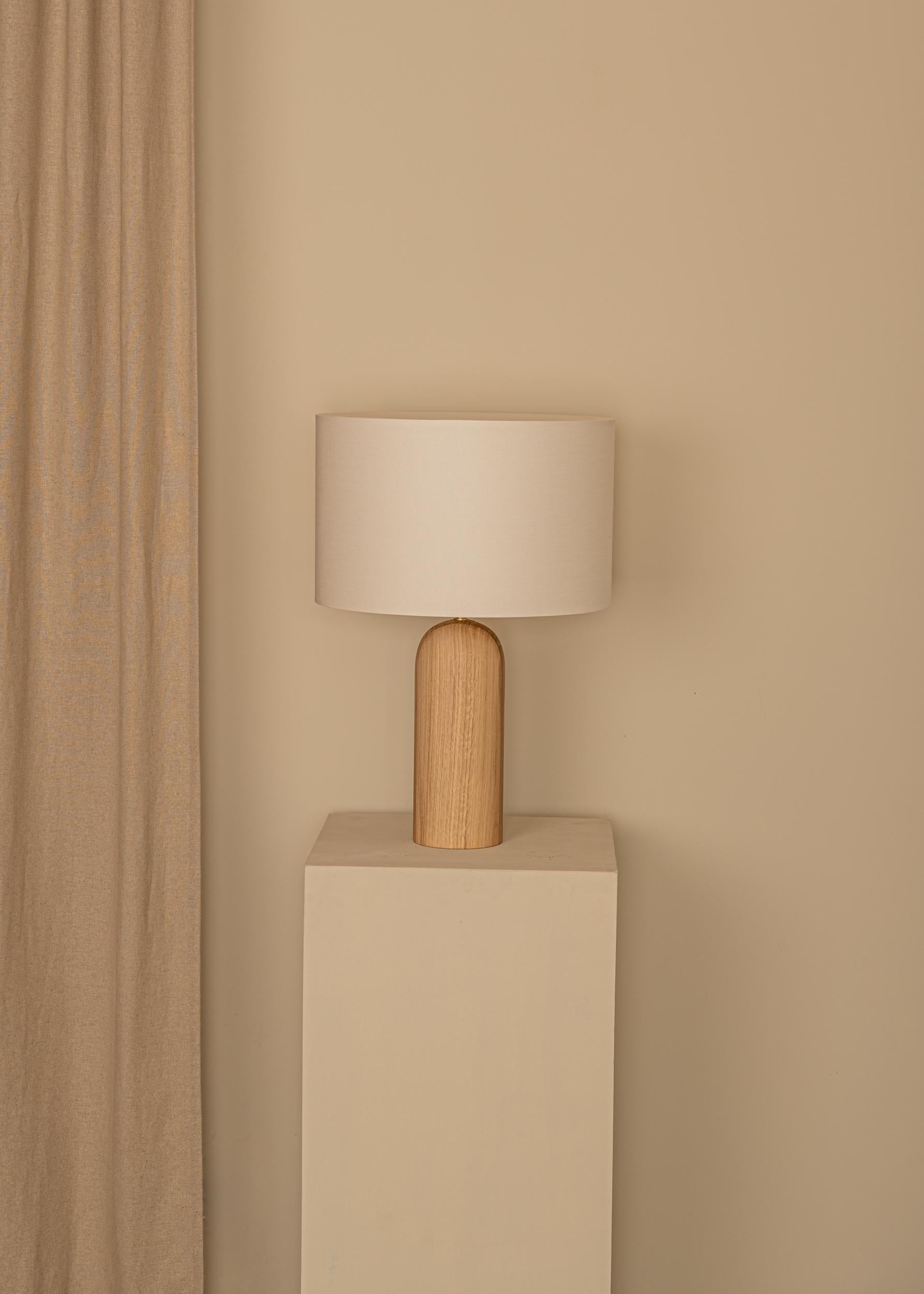 Oak Pura Table Lamp by Simone & Marcel
Dimensions: Ø 40 x H 58 cm.
Materials: Brass, cotton and oak.

Also available in different marble, wood and alabaster options and finishes. Custom options available on request. Please contact us. 

All our