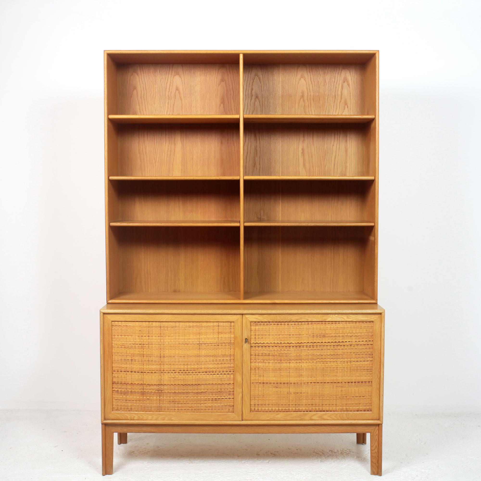 Elegant and very useful sideboard and bookcase model Norrland designed by Alf Svensson produced by Bjästa Möbelfabrik in Sweden 1960's.
The 2 elements can be separate.
Sideboard in oak with door covered with woven rattan and adjustable