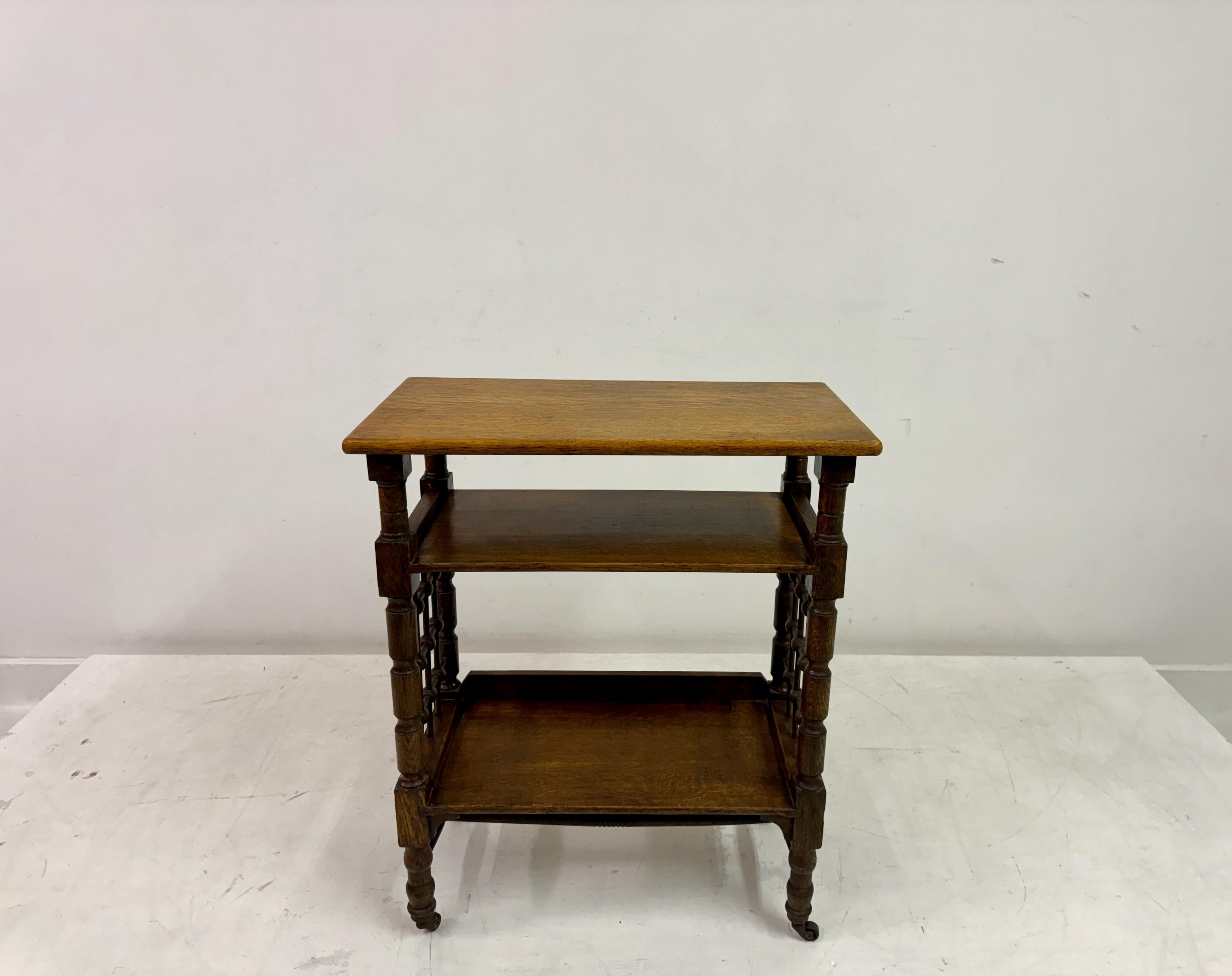 Book stand or reading table

Oak

By Leonard Wyburd for Liberty

Two tier

Moorish side panels

Turned legs

Brass castors

England Early 1900s