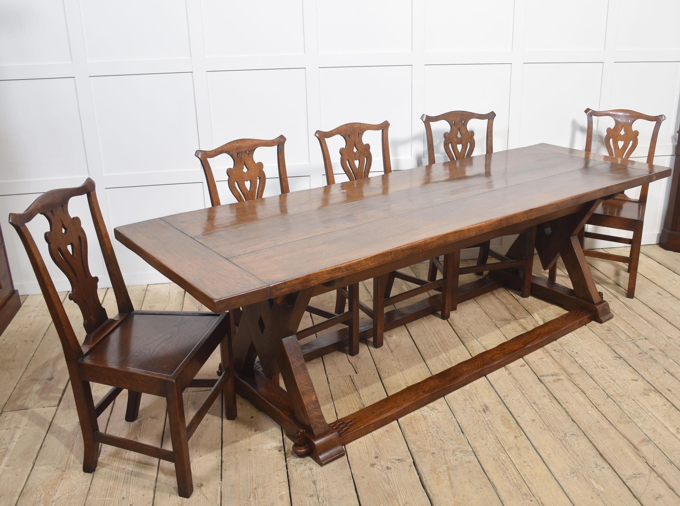 Large oak refectory table, the thick top with cleated ends raised up on square and compass slab ends united by stretchers.
Dimensions
Height 30 Inches
Width 100 Inches
Depth 32.5 Inches