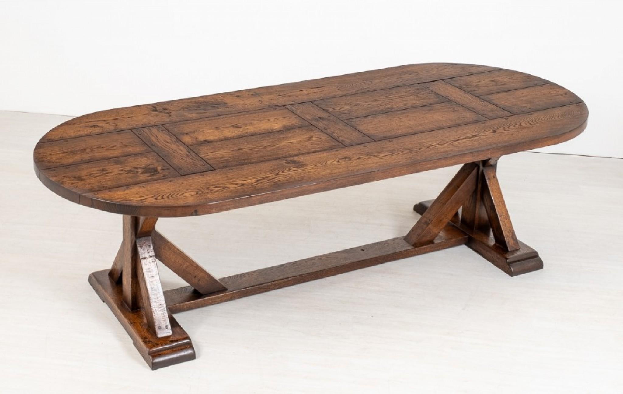 Solid oak refectory table of the medieval style.
The top of the table is made up of 4 planks with cross members and is of a bow ended form.
circa 1920
The base of the table featuring sleigh feet and crisscross uprights.
Held together with wooden