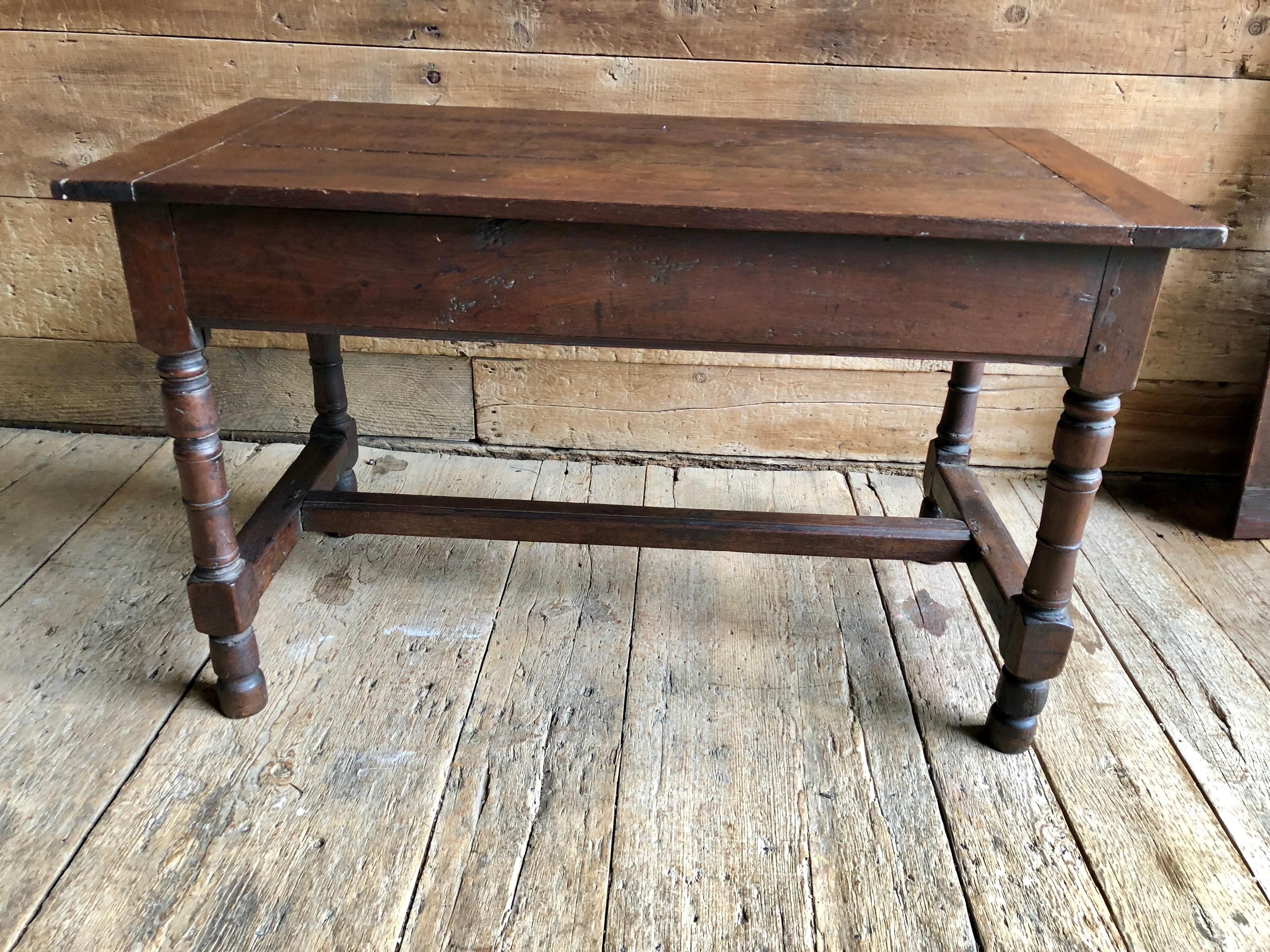 A rustic oak refectory table with two 22” plug-in leaves, circa 1690-1700, with turned legs and a stretcher, European. 92” long with leaves in.