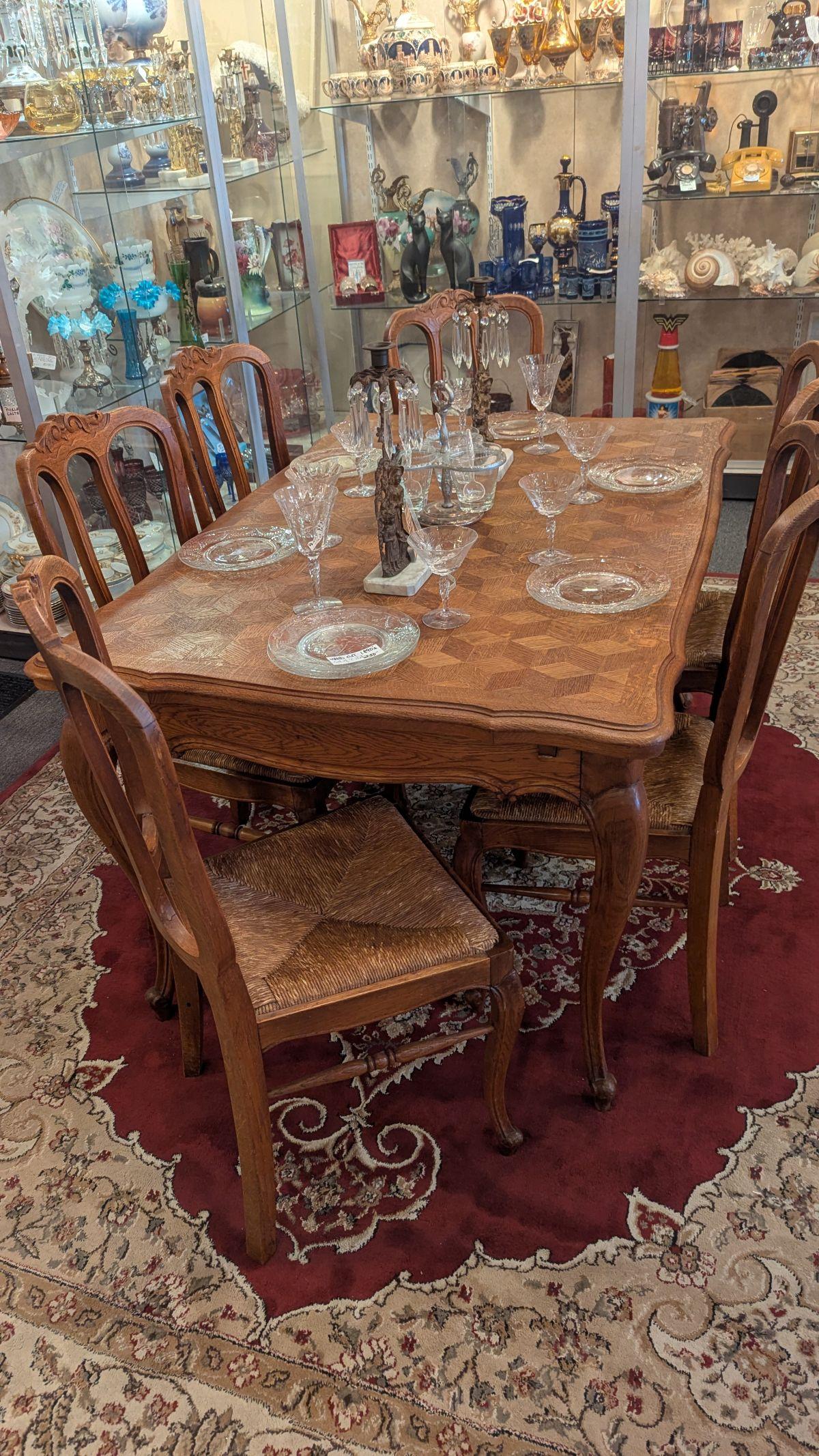 This is a beautiful and sturdy solid oak refrectory table with Queen Anne legs and carved skirt.  The two side pull out leaves hide under the table top, 37x54 closed and 37x94 when opened. The wonderful table top is solid oak marquetry (not veneer,