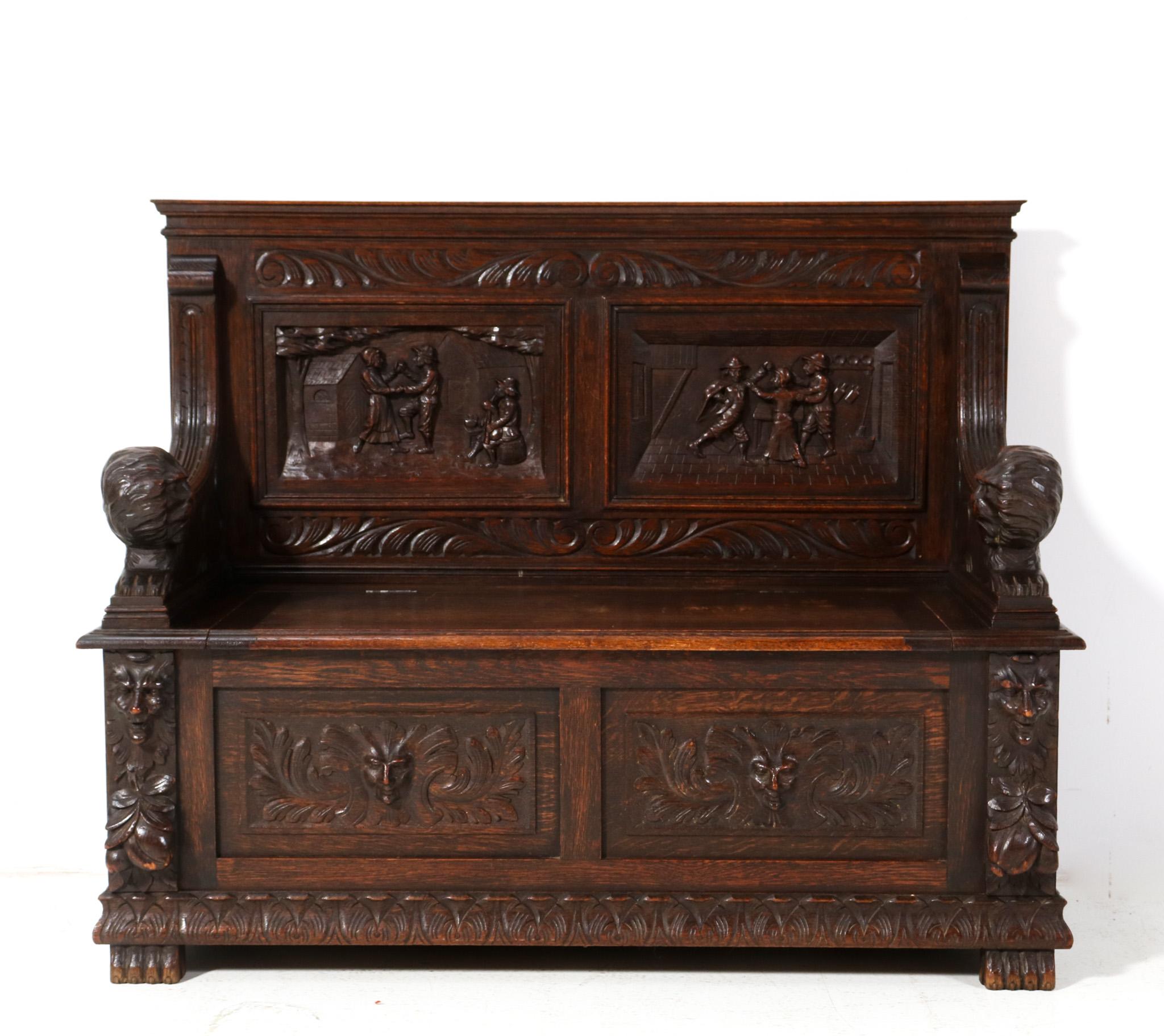 Magnificent and rare Renaissance Revival hall bench.
Striking Dutch design from the 1890s.
Solid oak base with original hand-carved lions as armrests and original hand-carved elements in the back.
Underneath the seat, there is room for storage.
This