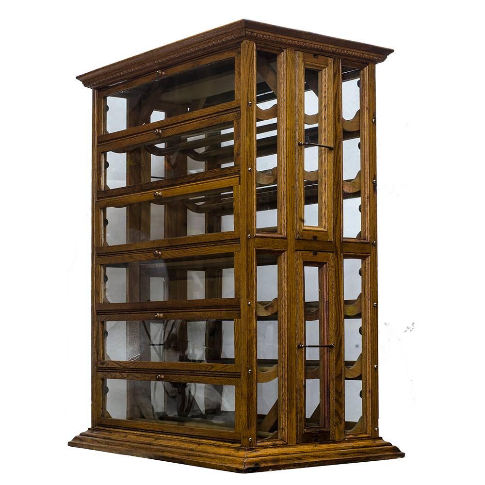 Made of solid quarter sawn oak, this early 20th century ribbon display cabinet has been recently professionally refinished and is in beautiful condition. Manufactured by A.N. Russell and Sons, the original brass label plate is intact, with all of