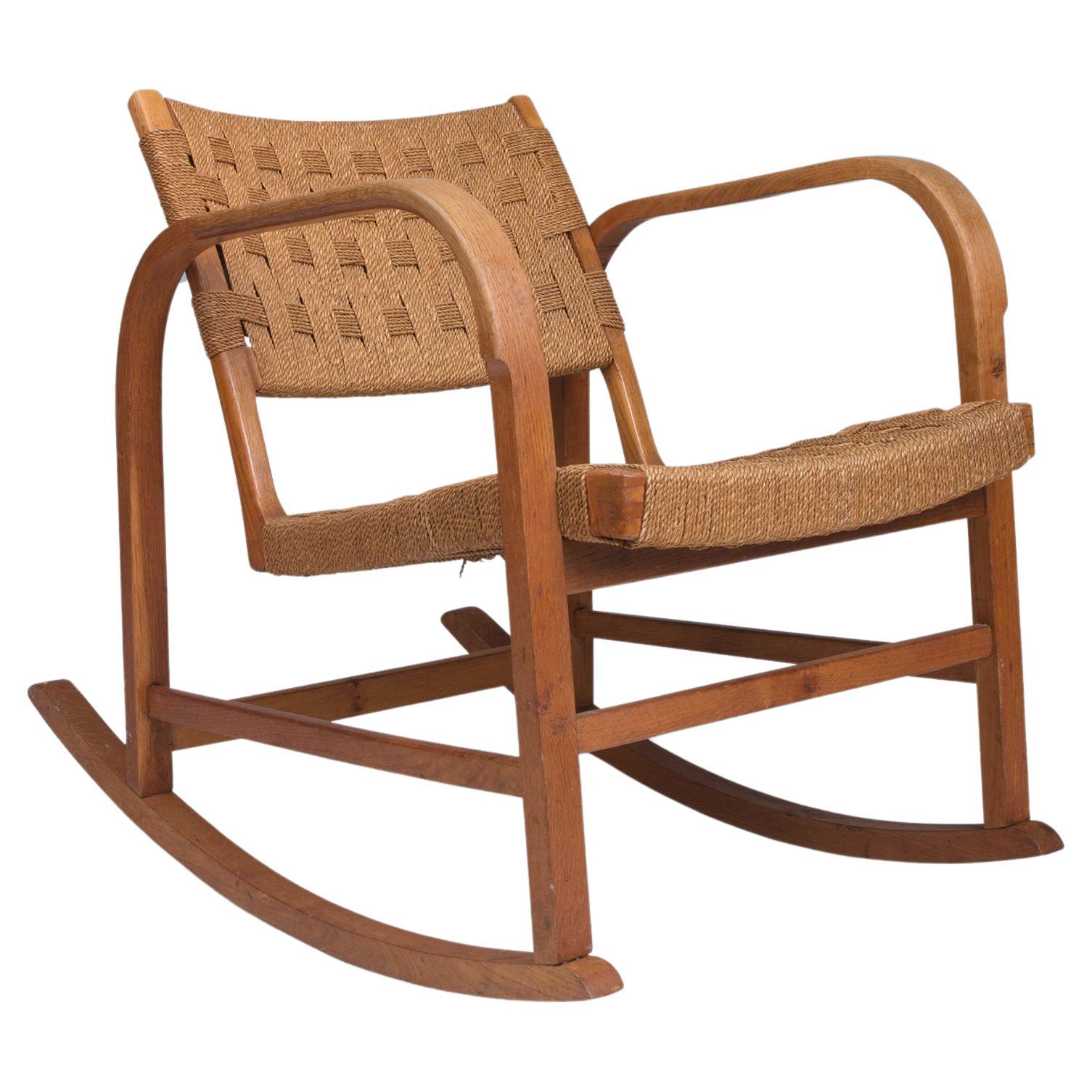 Danish modern oak rocking chair with curves and seagrass seat