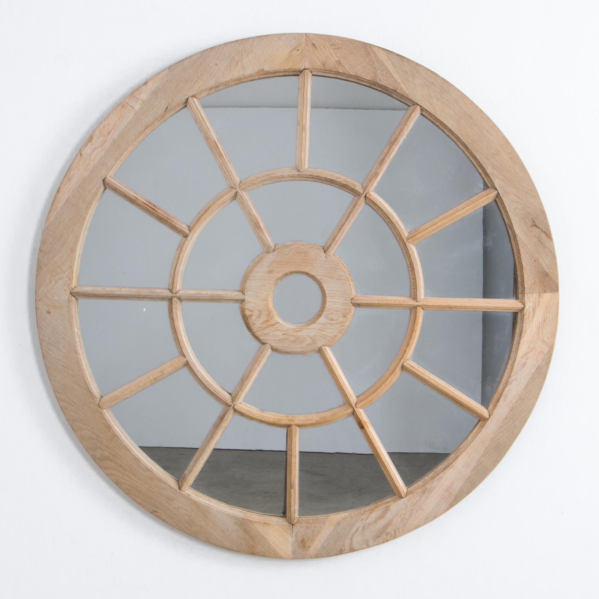 A prototype from our atelier, this wooden mirror was created as a modern interpretation of traditional architectural forms. In prototypical oak, concentric circles make a bull’s-eye frame for muntin pieces, the typical dividers for window frames.