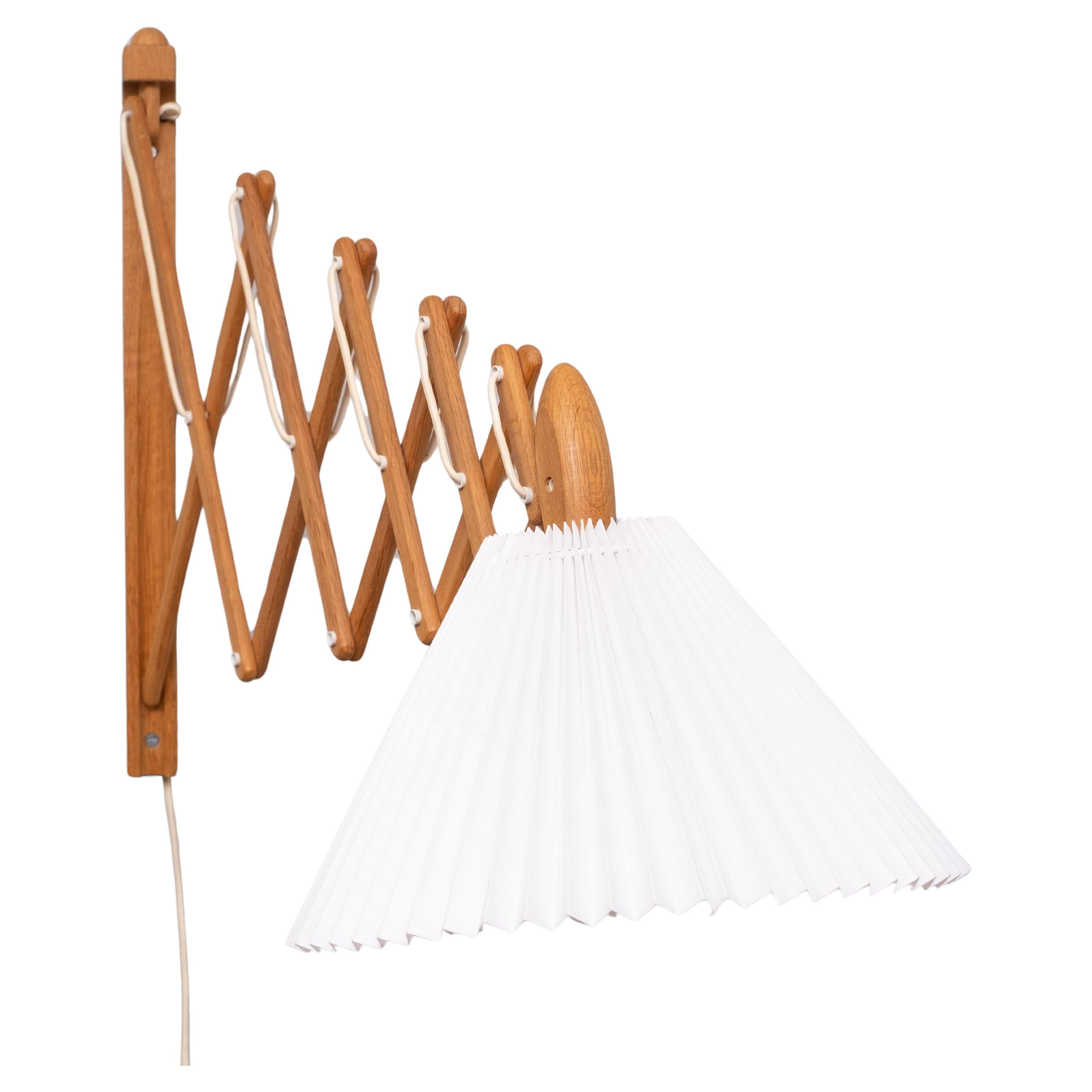 For sale is this iconic Le Klint scissor wall lamp, in teak Design by Erik Hansen in the 1950s.
This is a large specimen measuring 127cm 50 inches off the wall. Comes with its original 
Hand-bent acrylic lampshade. A large E27 bulb is required.