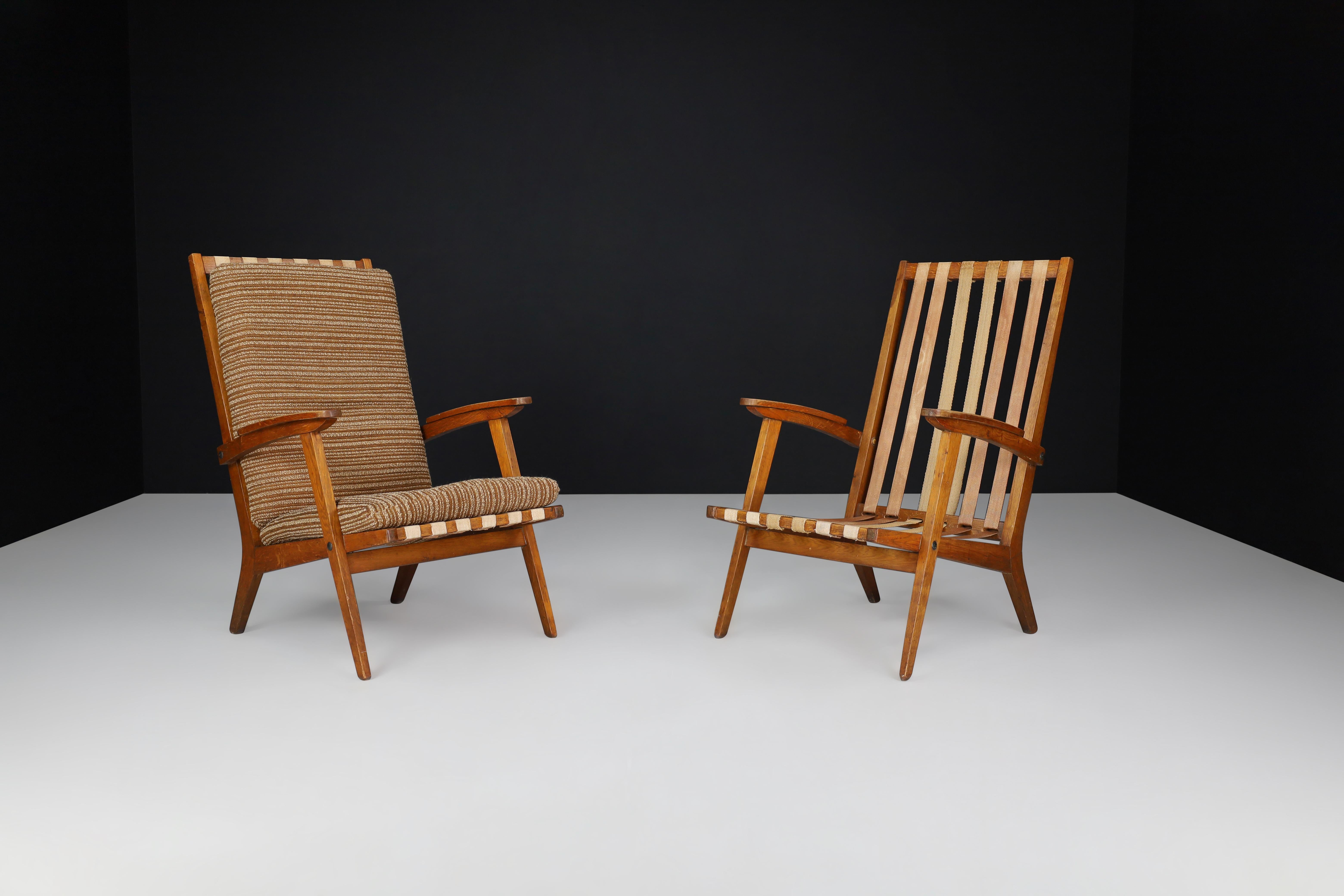 Oak Sculptural Lounge Chairs with Brown Upholstery, France 1950s. 

midcentury oak lounge chairs manufactured and designed in France 1950s. These elegant chairs have the original upholstery fabric and a lovely French oak frame. It is in excellent