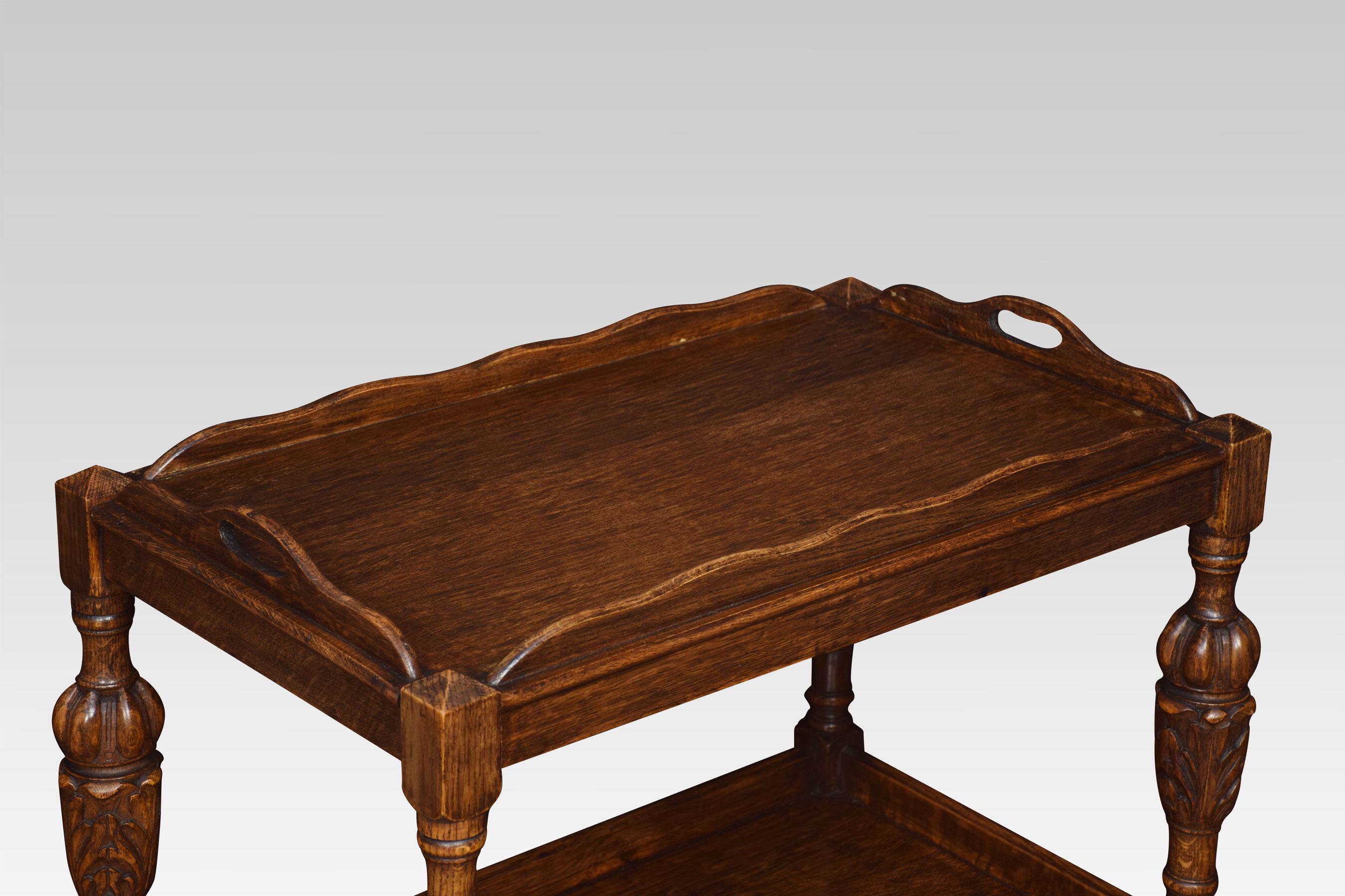 Oak trolley, the lift-off tray raised on acanthus carved supports terminating in castors, united by under tier.
Dimensions:
Height 31.5 inches
Width 31 inches
Depth 19 inches.