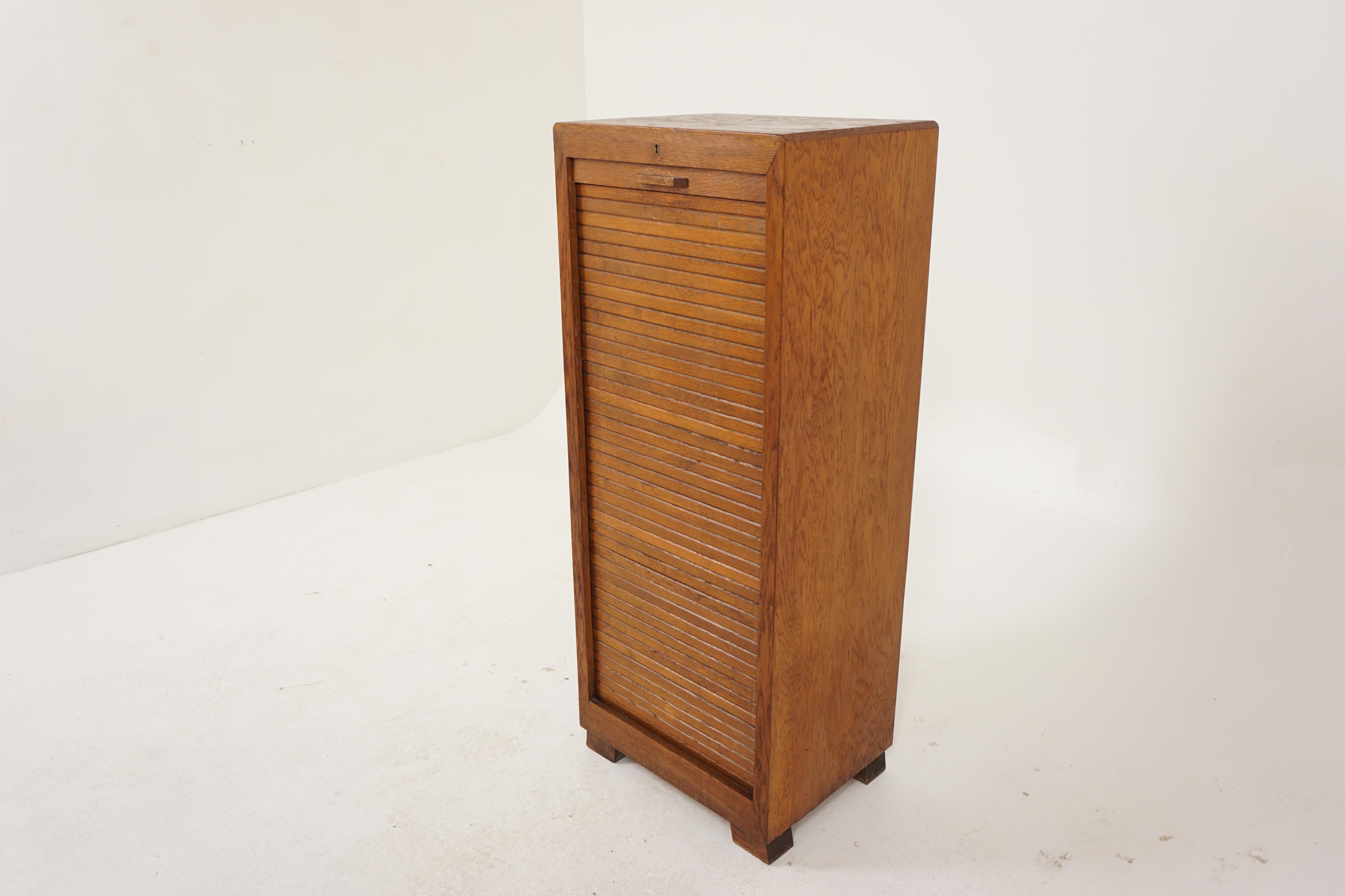 Oak shutter front tambour file cabinet, Sheet Music cabinet, Scotland 1930, B2950

Scotland 1930
Solid Oak + Veener
Original finish
Rectangular Top
Shutter front roll down and roll up
Opens to reveal seven slide out trays
All standing on