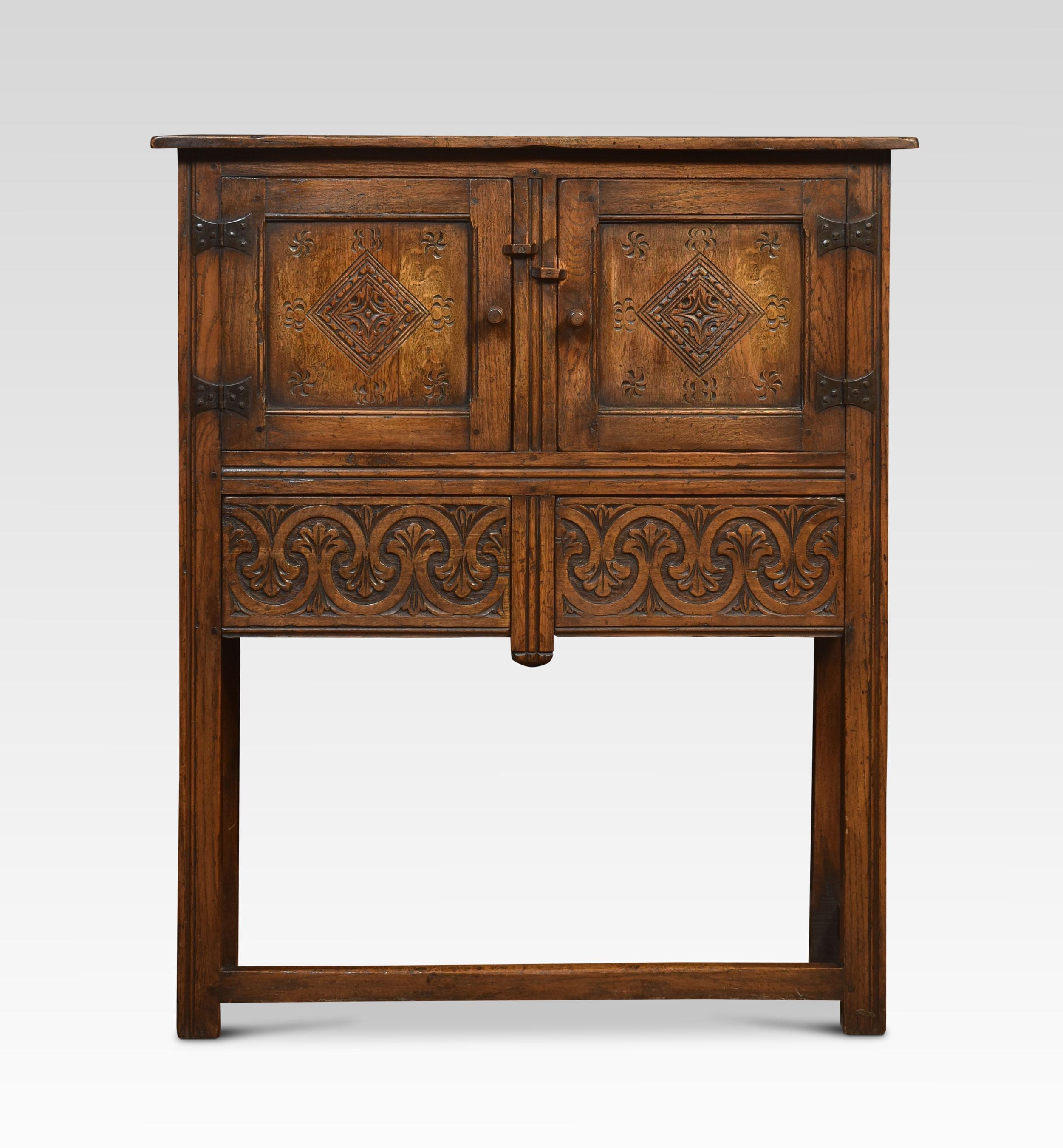 Oak cabinet the molded top above a pair of carved paneled doors with iron hinges, opening to reveal a large cupboard. The frieze is fitted with two drawers, all raised up on square supports united by stretchers.
Dimensions
Height 46.5