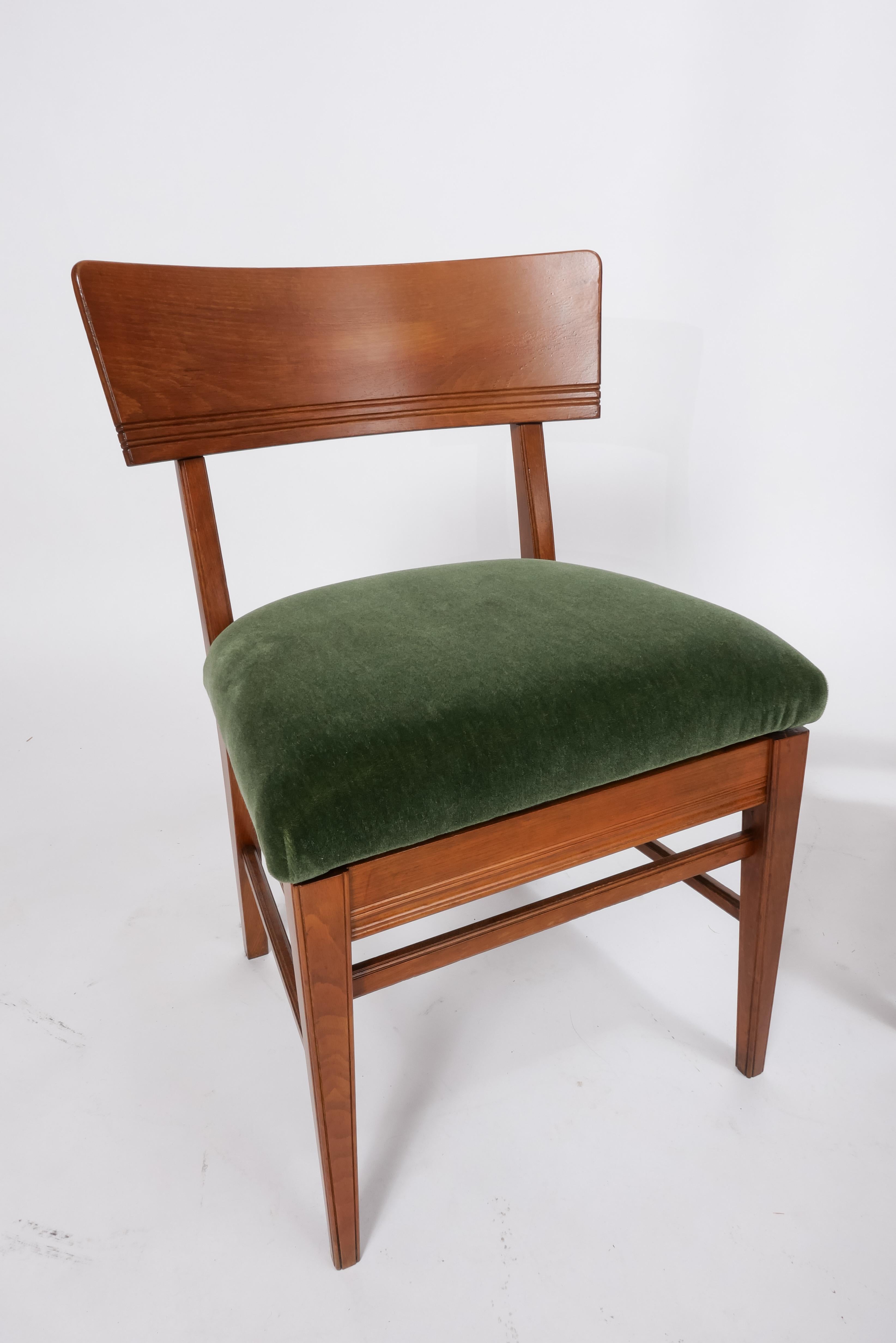 Architect Martin Nyrop designed these chairs for Copenhagen Town Hall in 1905. They are an important example of the Danish Arts and Crafts movement in design. The pair have been restored and freshly reupholstered in luscious moss green mohair from