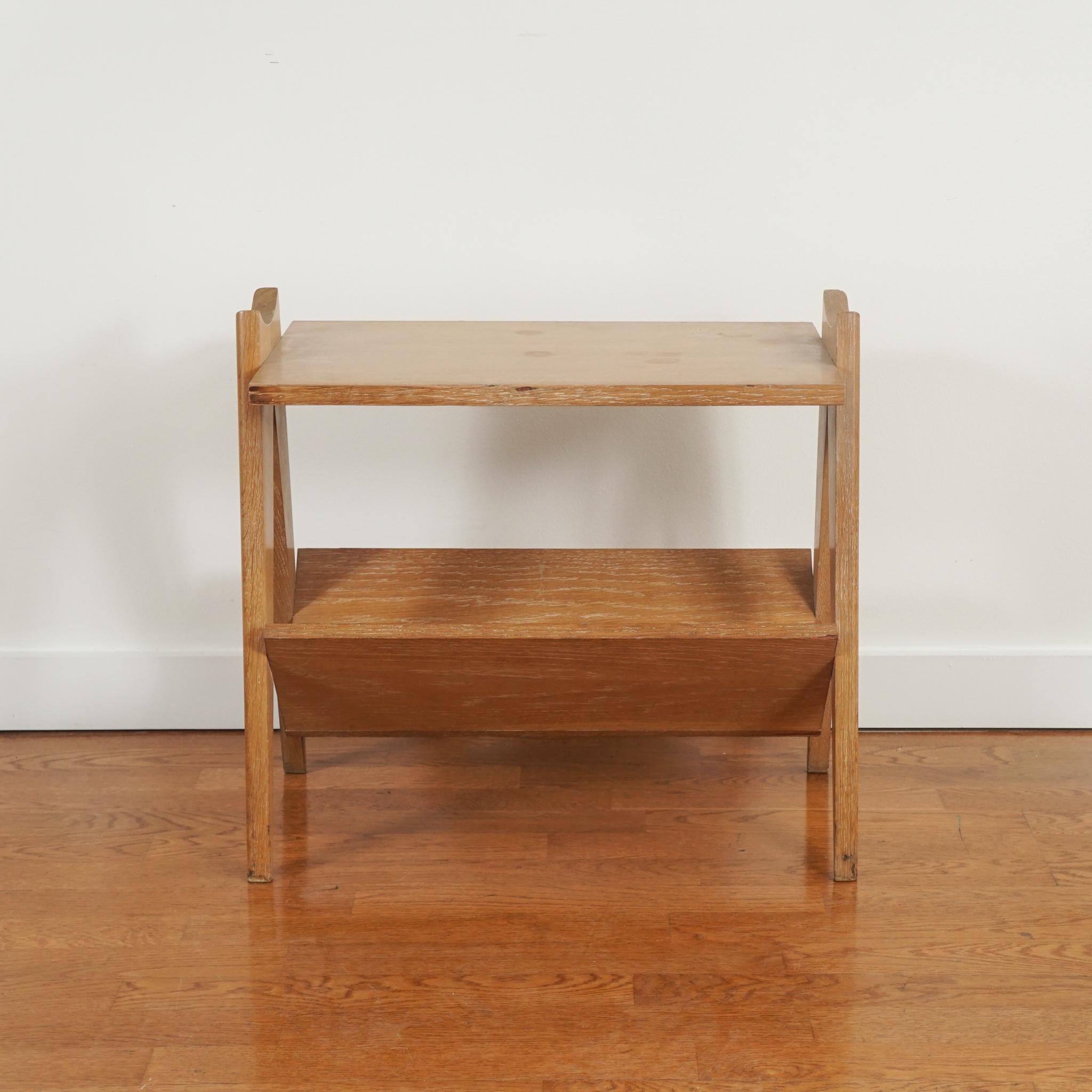 This unique oak side table was made by Robert Guillerme and Jacques Chambron—the French creative team behind Votre Maison. Made in the 1960s, the honey-colored oak side table with magazine storage below is distinctive in its simplicity, scale and