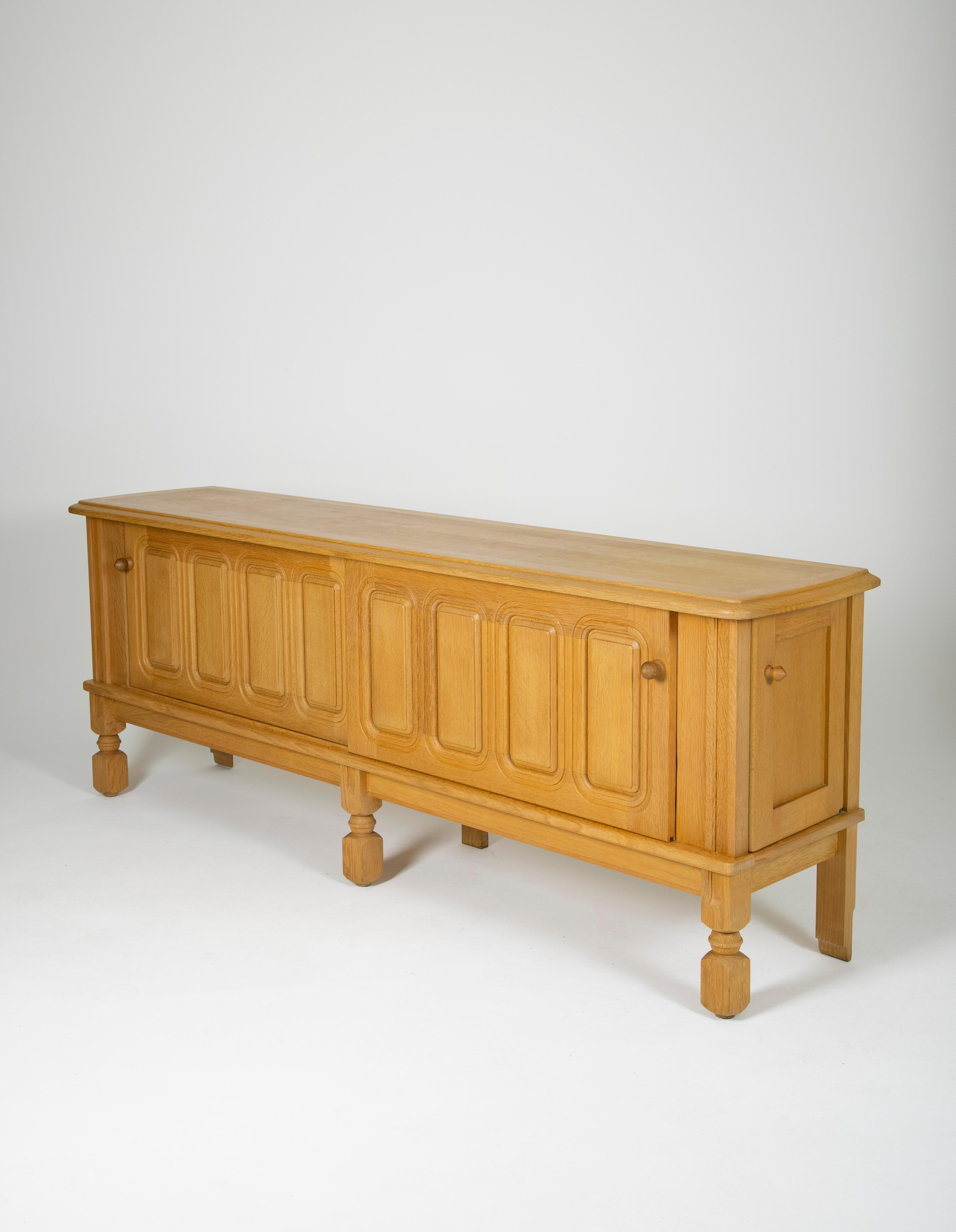 Solid oak sideboard by Robert Guillerme & jacques chambron produced in france in the 1960s. This sideboard has two sliding doors and four drawers on the right side. The sliding doors are worked with elegant carved patterns. Excellent condition.
LP581