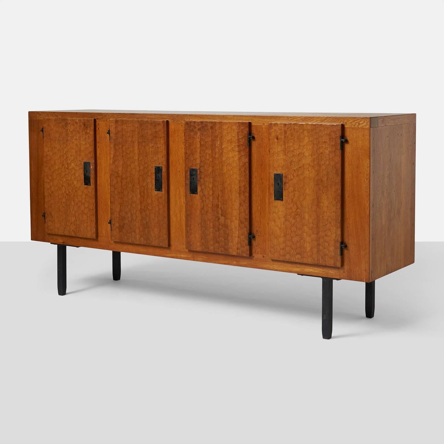 Jean Touret sideboard for Atelier Marolles.
A unique oak sideboard by Jean Touret for Atelier Marolles in a perfect condition. There are four working lockable doors three pull-out drawers behind the right door. Beautiful natural aged patina to the