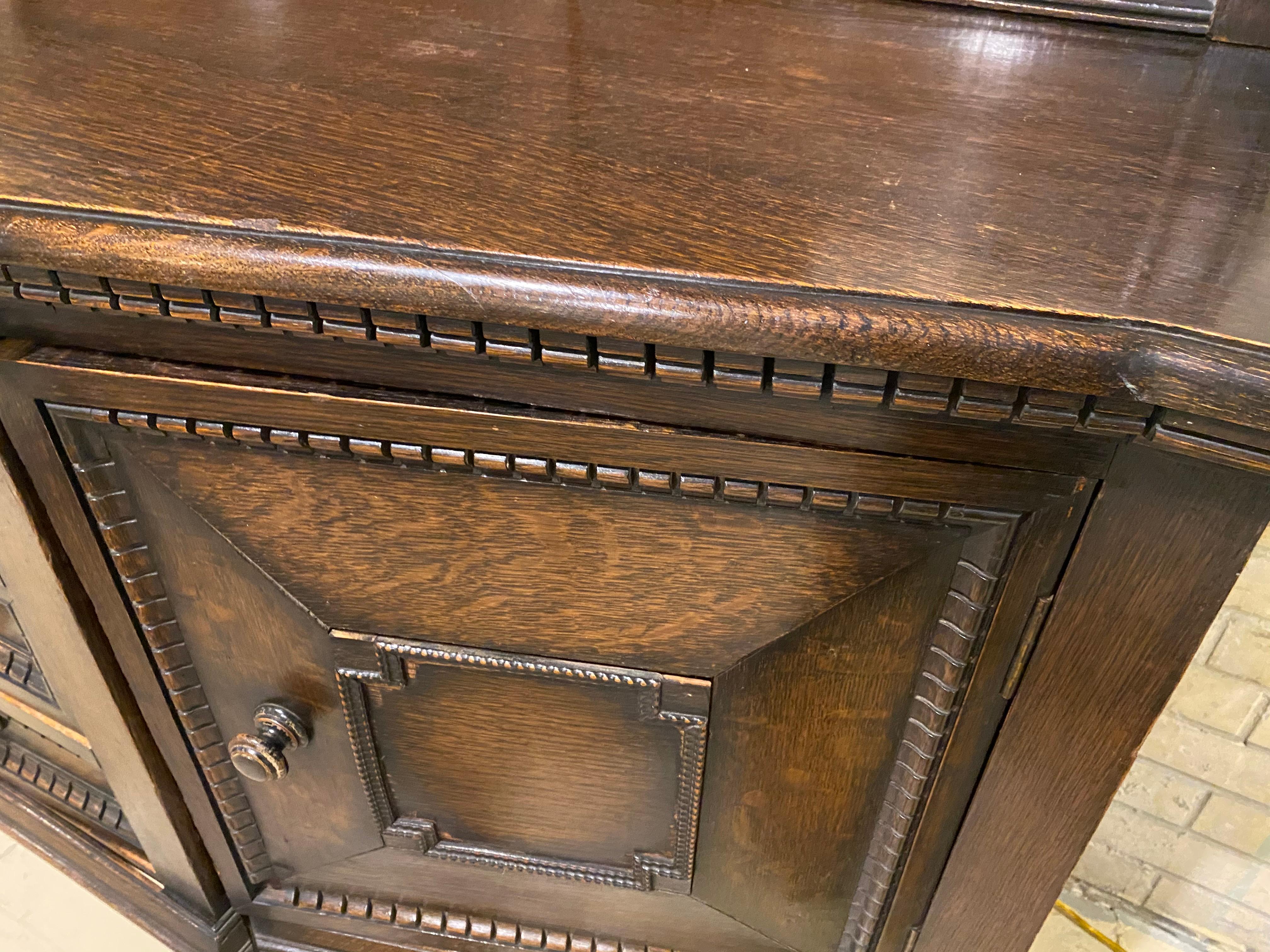 Oak sideboard made with solid and veneers with carvings and detail.