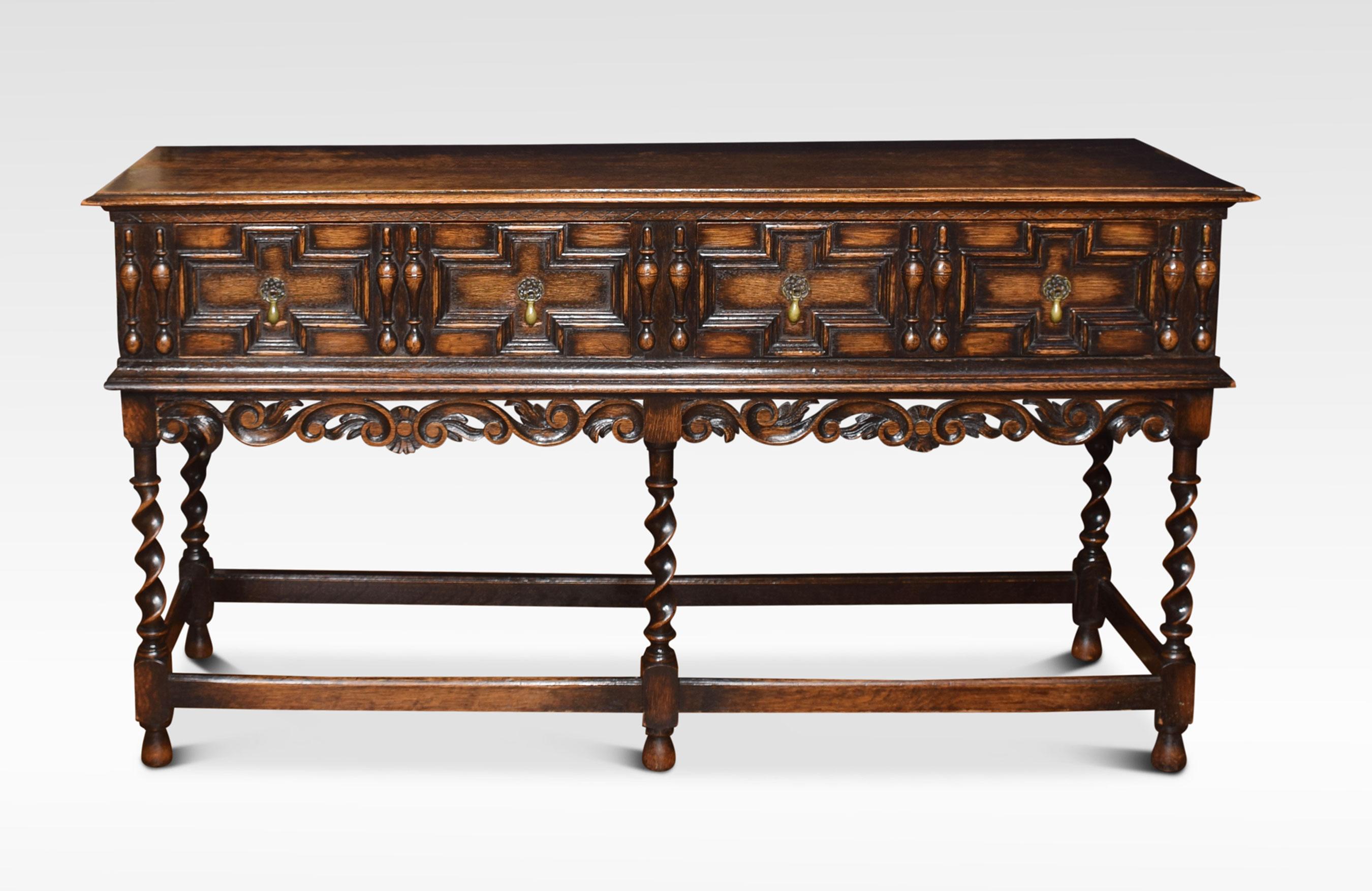 Early 20th century oak sideboard of Jacobean design, the large rectangular top with moulded edge above four freezes drawers with brass drop handles. All raised up on barley twist supports united by stretchers.
Dimensions:
Height 30 inches
Width