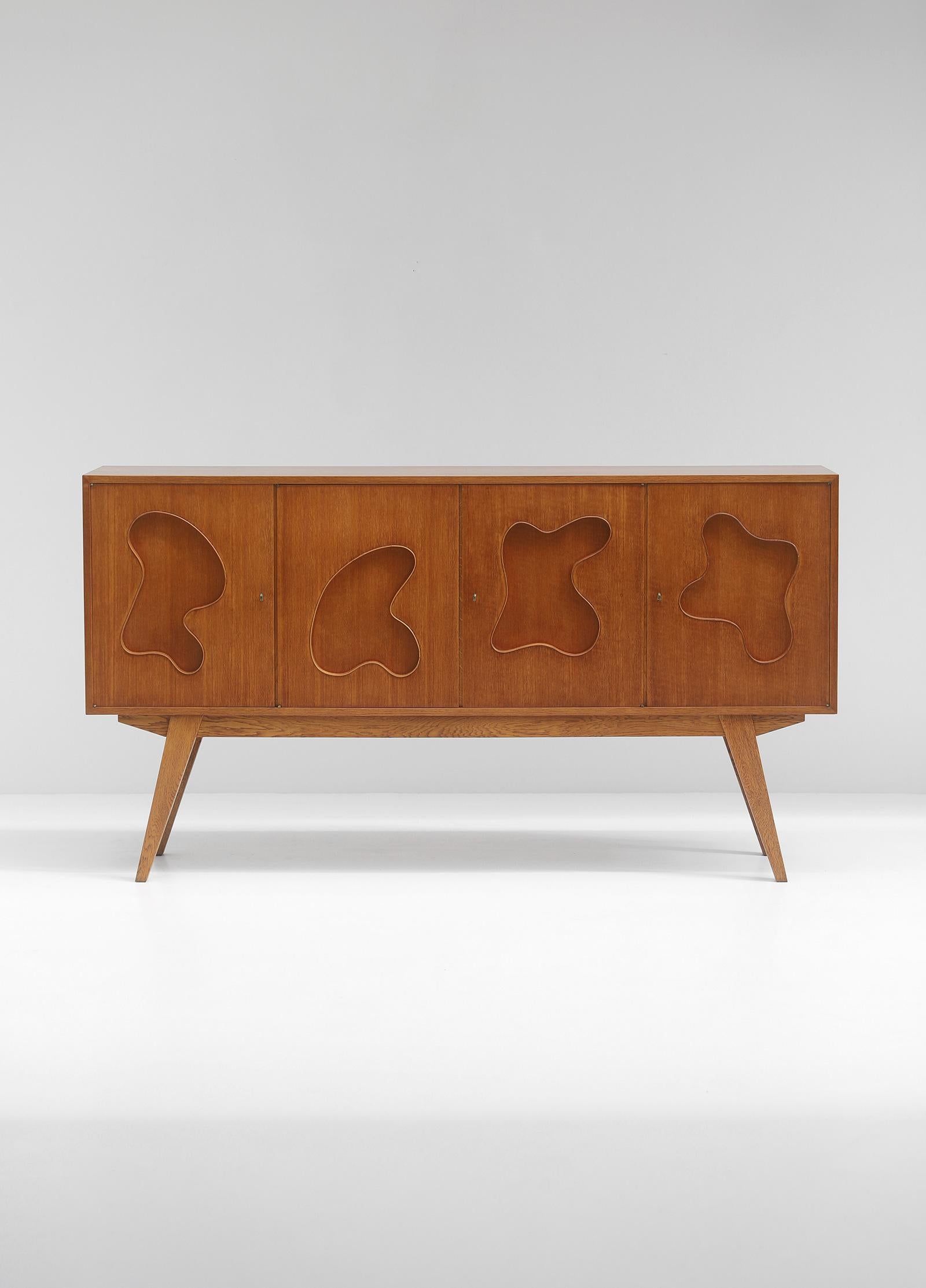 I am always on the hunt for unique sideboards and this is one of them. The design is so far unknown but the door panels and the detailed hinges remind me on a inspired work of Jean Royere. Although this is probably not a work of him, this sideboard