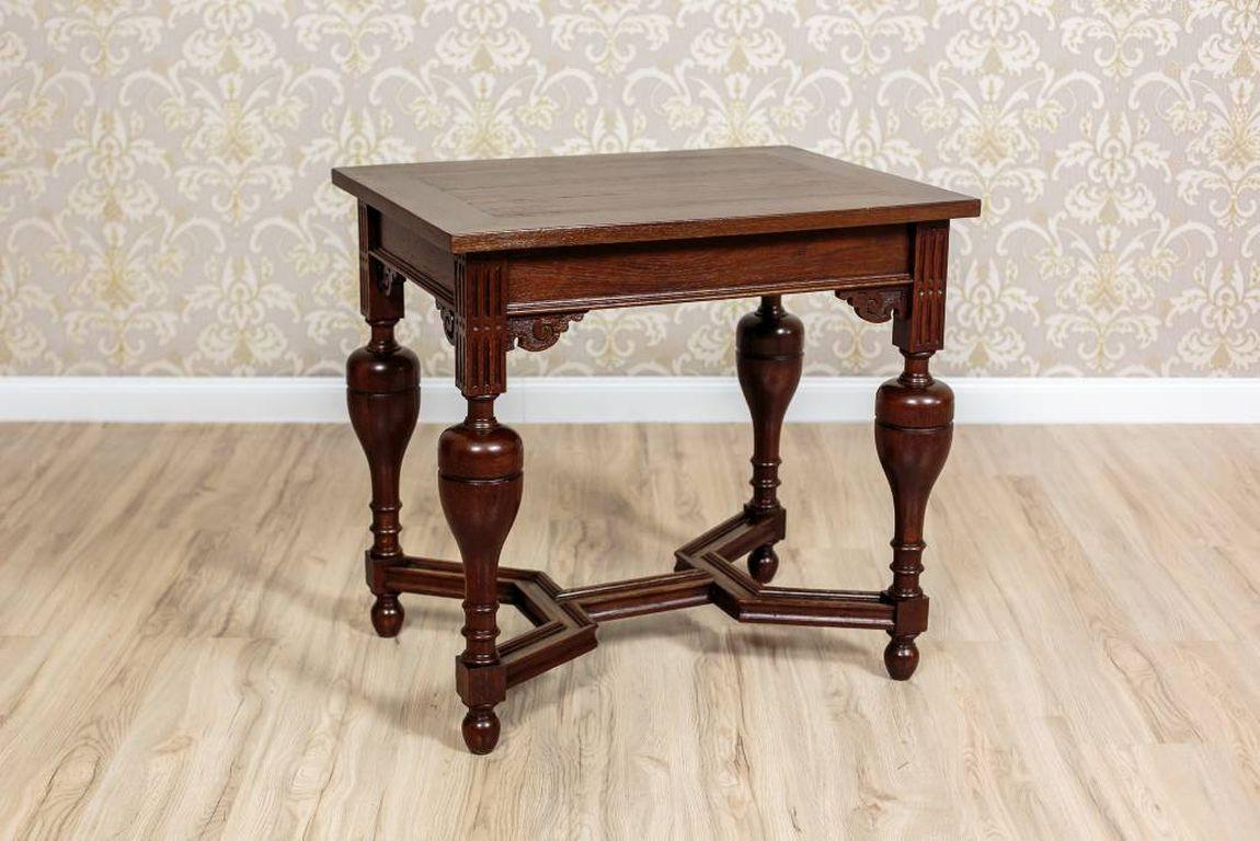 A small, rectangular table circa 1920, whose form is in the style of the Dutch Mannerism.
This piece of furniture was made in oak wood.
Simple, rectangular table top is supported on striking, turned legs, joint together with the stretchers of