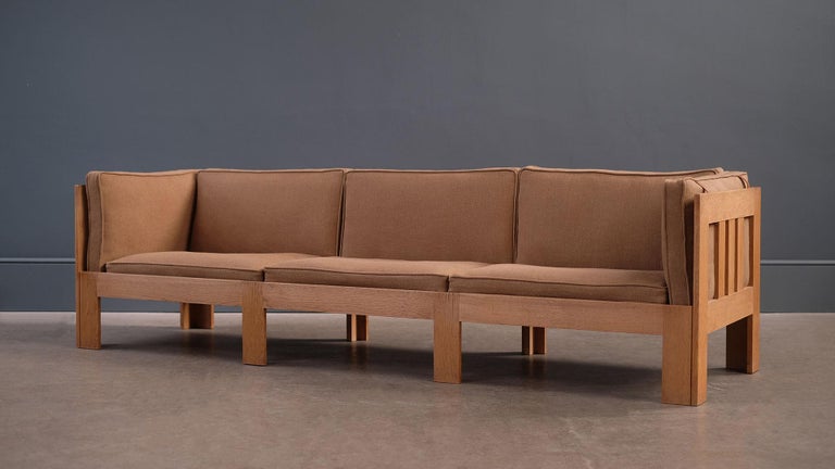 Exceptional large Danish sofa in solid oak designed by architect Tage Poulsen in 1963. Very rare large model in beautifully patinated oiled oak with new fabric covers by Kirkby Design. Wonderful design, excellent quality and super comfortable sofa.