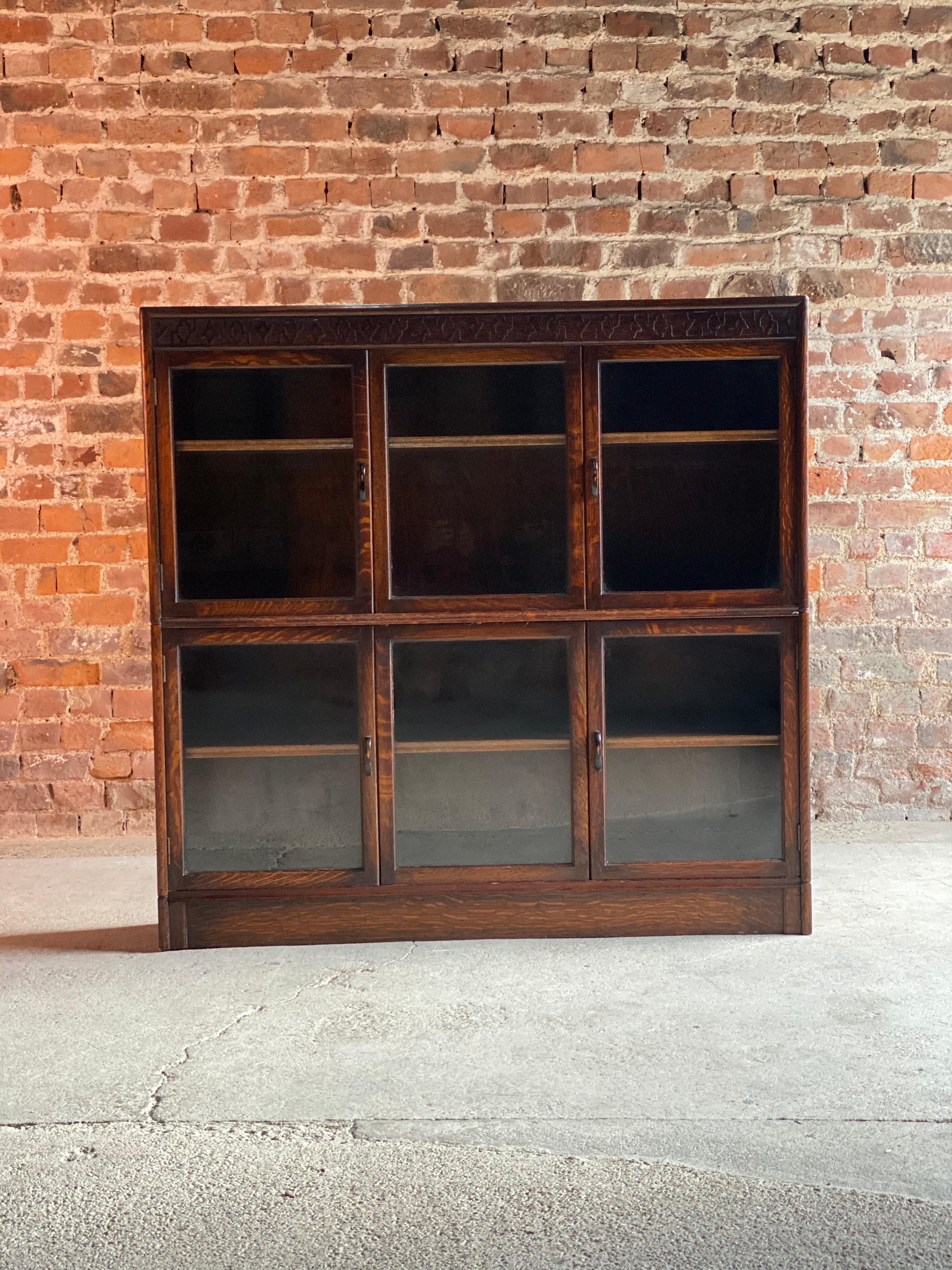 Oak stacking bookcase by Gunn USA 1920

Magnificent 1920s oak sectional bookcase by Gunn, the rectangular top with patterned relief over four doors with two central sliding panels all with original glass panels, two long adjustable shelves within,