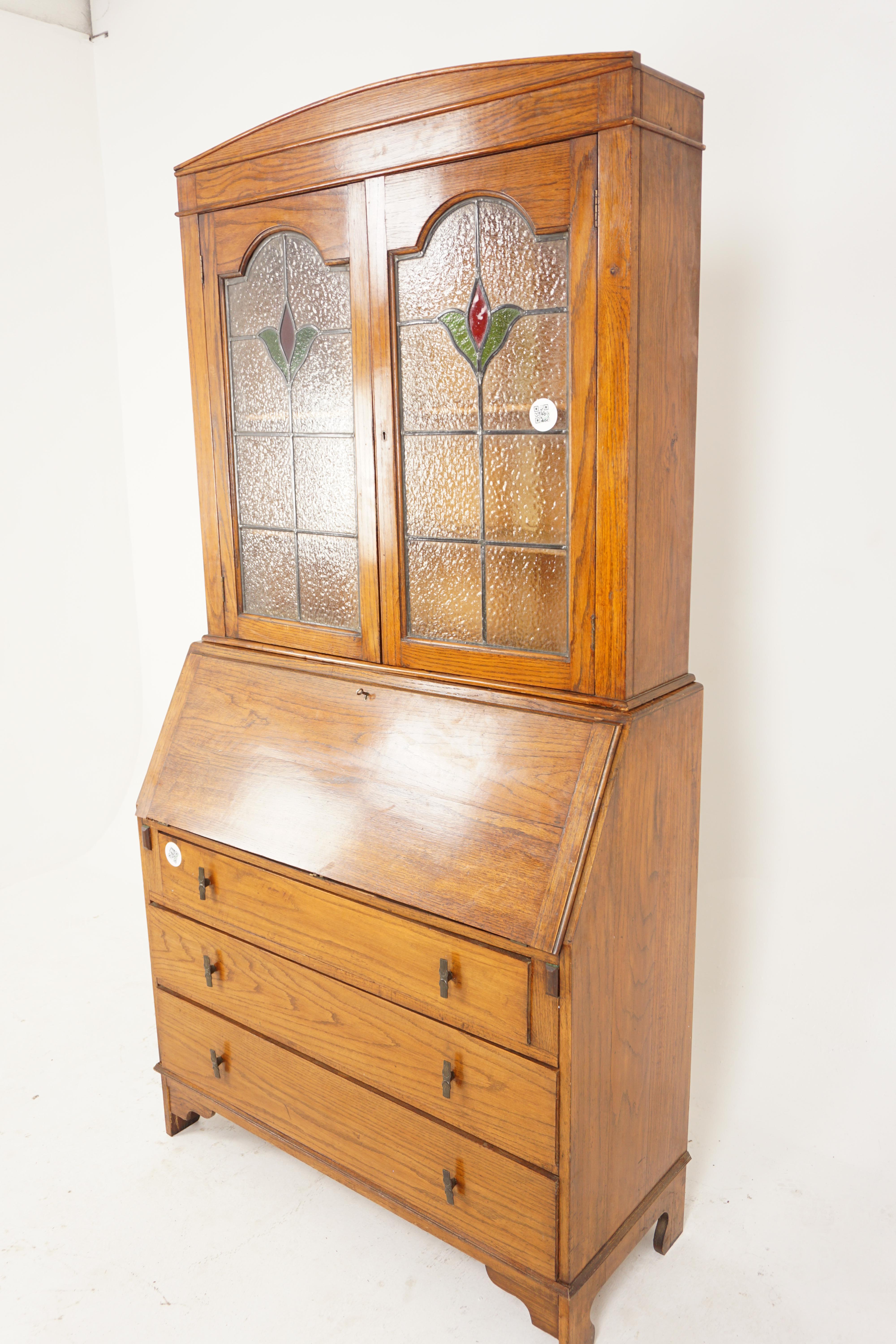 Vintage oak stained glass window slant front desk with bookcase top, desk, Scotland 1920, H800

Scotland 1920
Solid Oak
Original finish
Rectangular top
Shaped top with a pair of leaded glass doors
It has two adjustable oak shelves
The ball