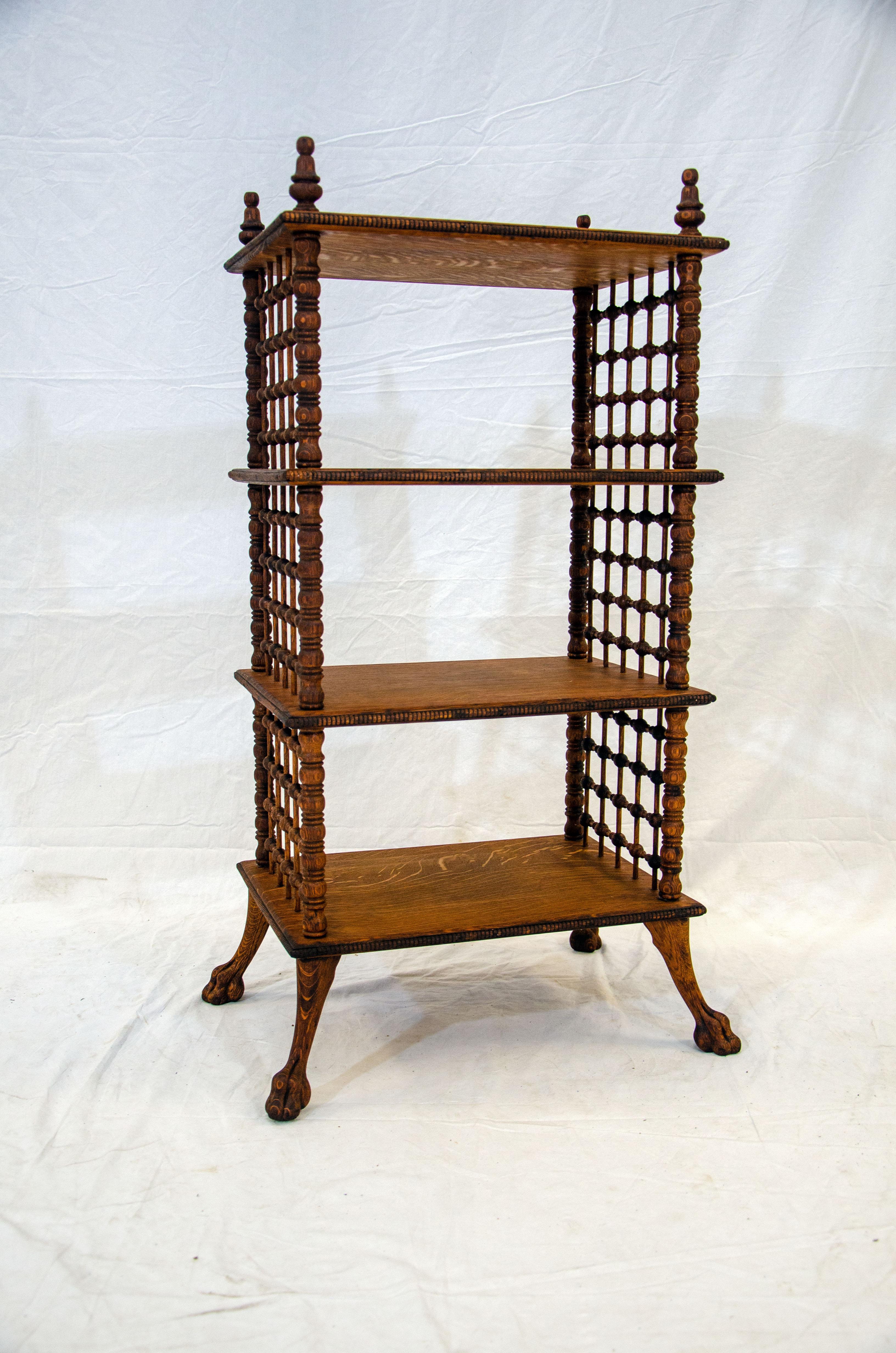 This unusual antique quarter-sawn oak stick and ball fretwork shelf would work well for book and magazine display or storage as well as a collection of small items. There are three shelves accented with wood beading around the edges and stick and