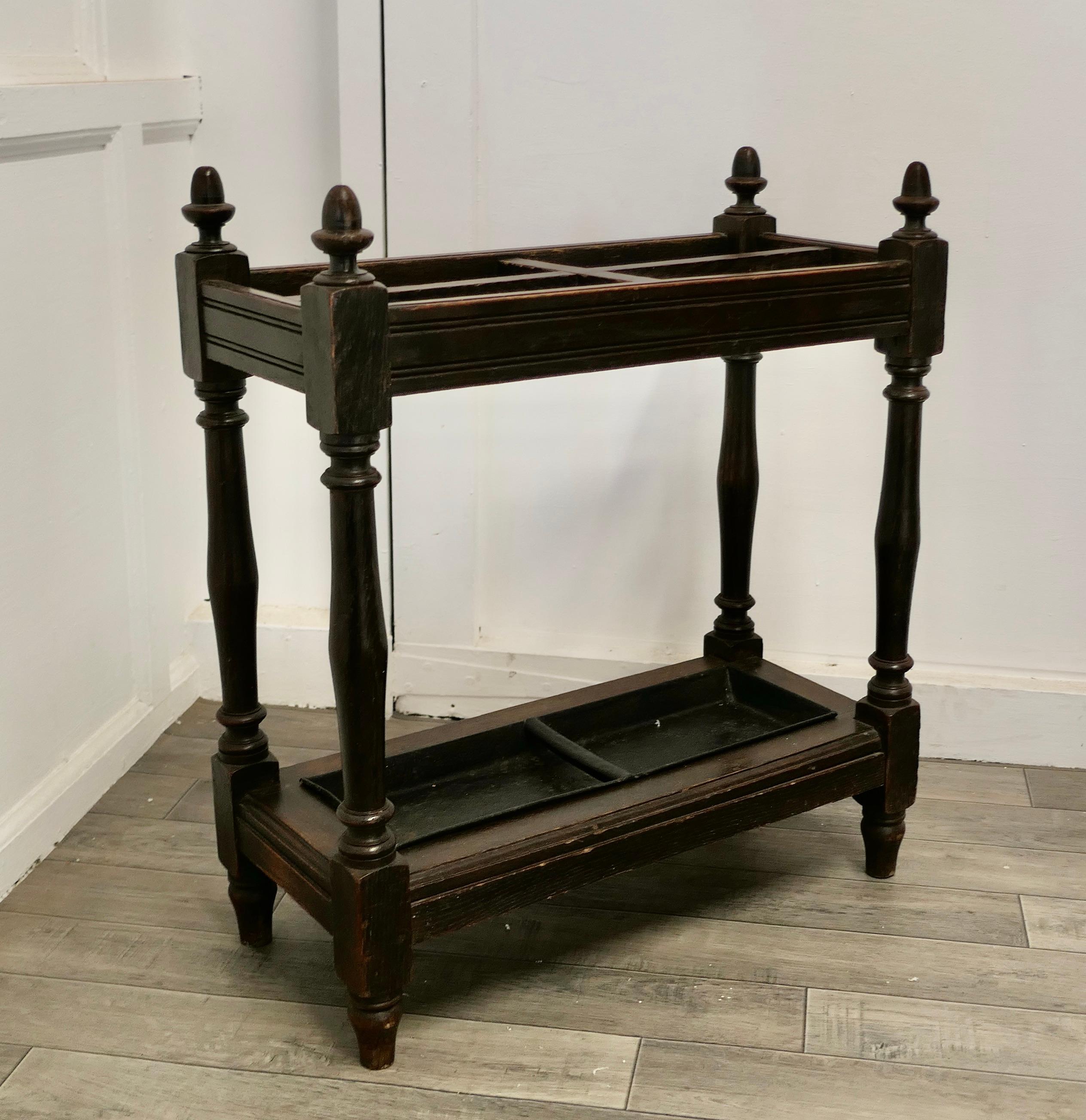 Oak Stick or Umbrella hall stand

The stand is made in Oak, it has turned uprights, the top is divided into 4 sections and will hold both Walking Sticks or Umbrellas, it also has a full length drip tray
The stand is 27” high, 24” wide and 11”