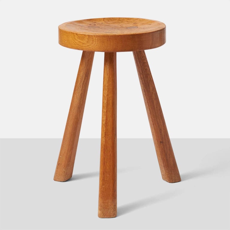 A rare oak stool on three square legs and a beautifully carved seat, by Jean Touret for Atelier Marolles. The stool is branded by Marolles and has the original rich aged oak patina. This piece was part of a large estate of Touret items, bought