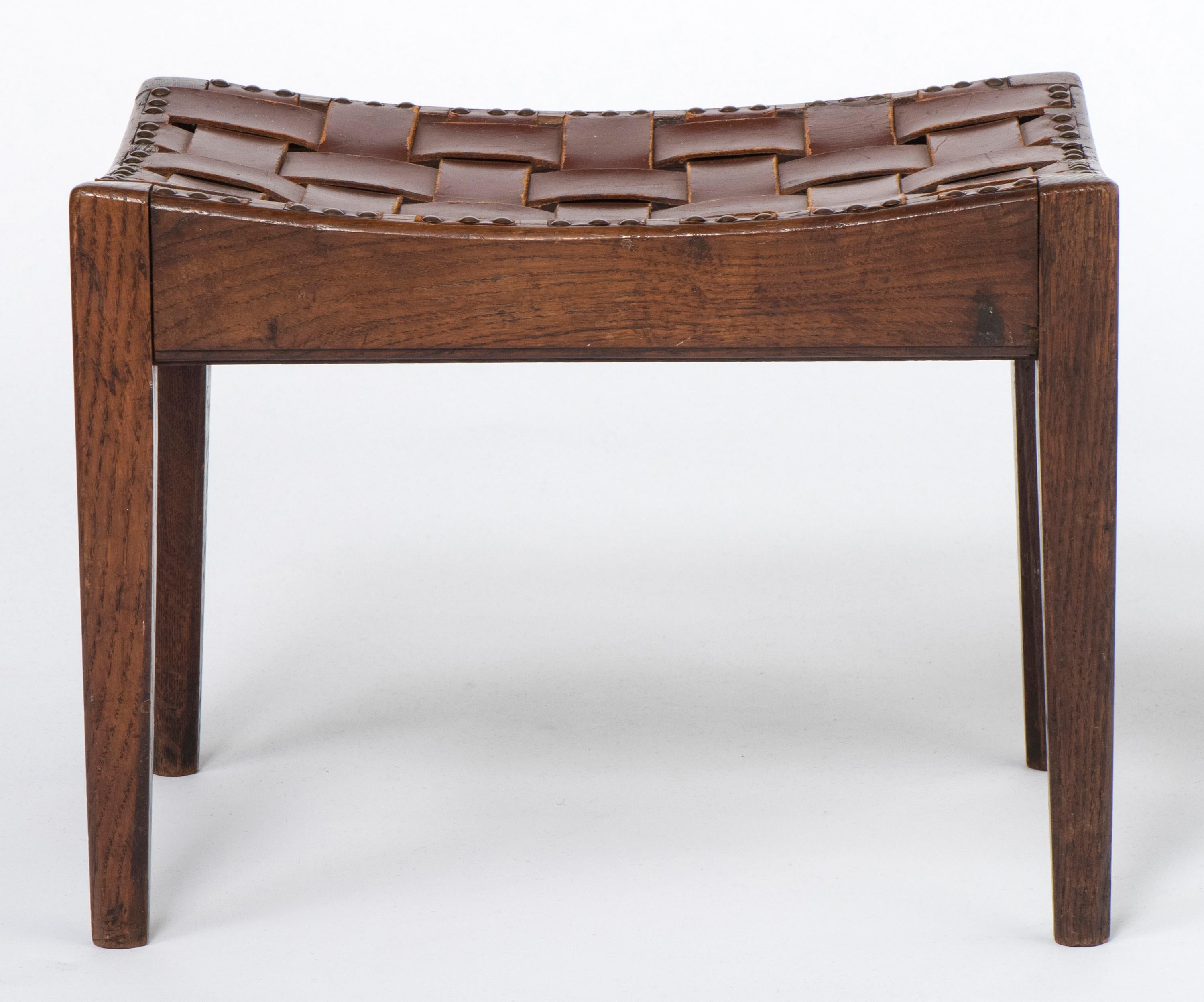 Oak stool by Arthur W Simpson of Kendal. (1854-1922)
Of simple rectangular concave seats with leather slatted tops.
Tapering legs.
Labelled “Arthur Simpson The Handicrafts Kendal”
England, circa 1920.
Measures: 40 cm wide x 30.5 cm deep x 30.5