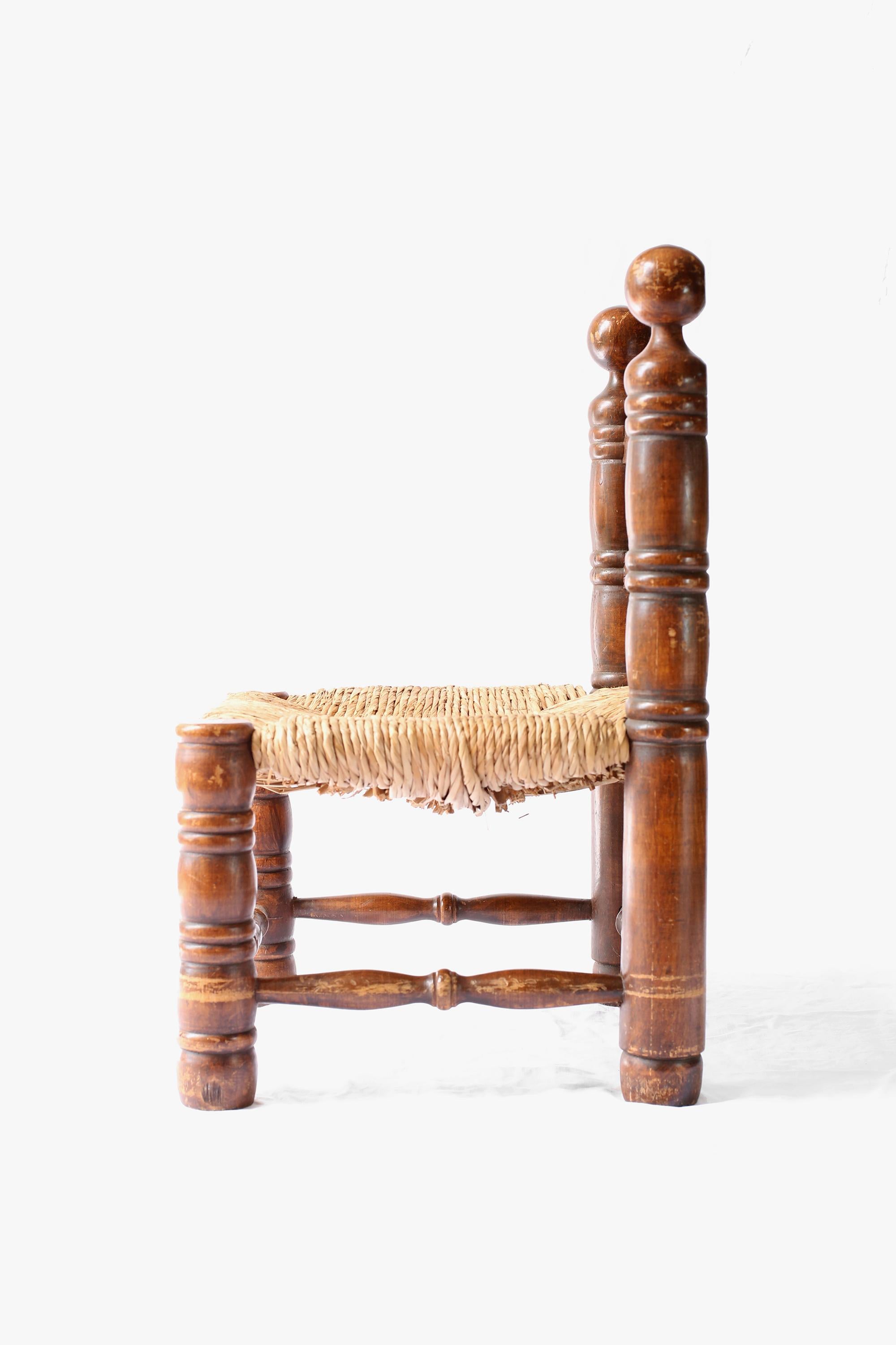 A charming turned oak and straw low chair very much in the manner of Charles Dudouyt. French, c. 1940s.