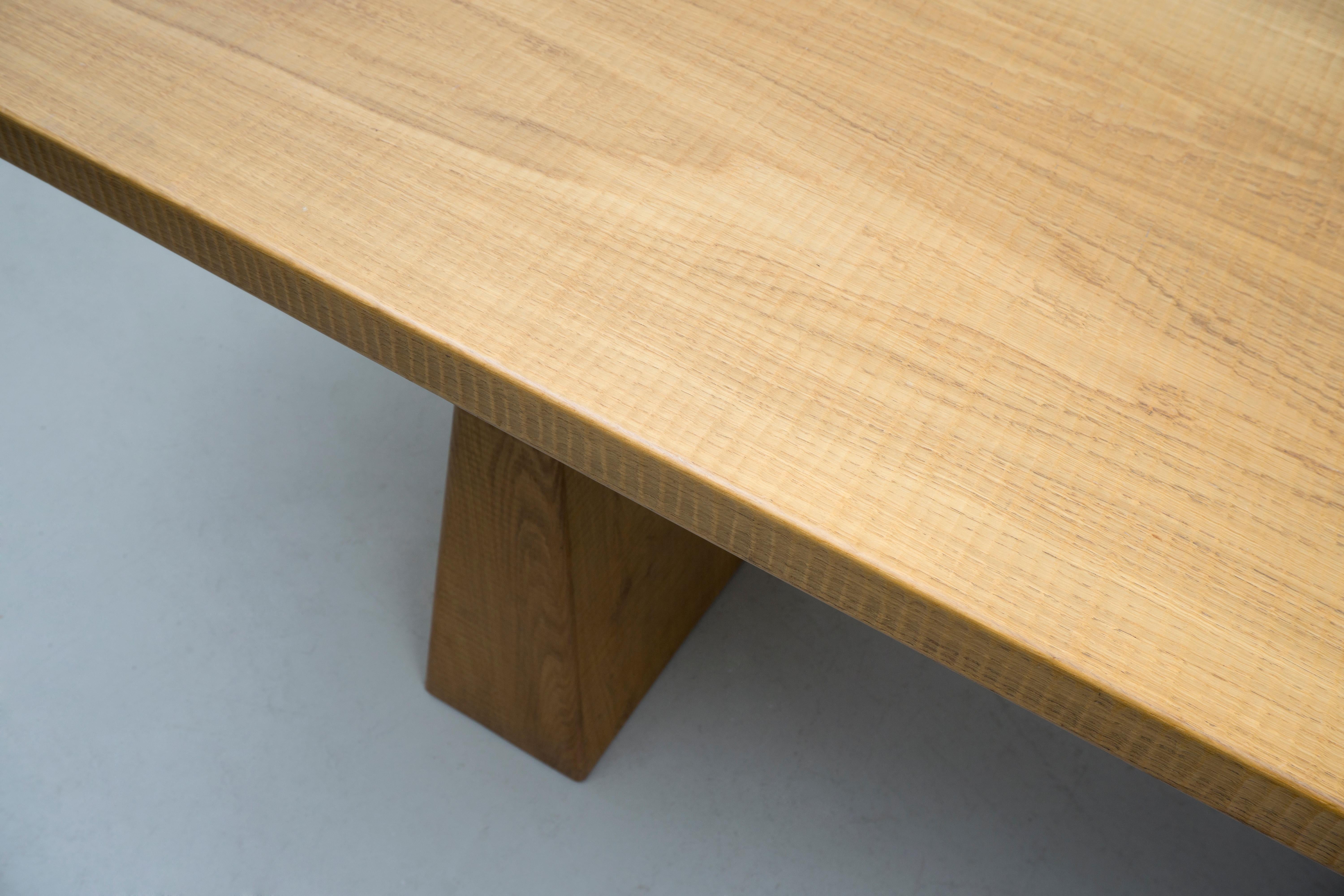 This rare and unique solid oak table was handmade in a small studio in Brescia, Italy around 1975 by the designer and manufacturer Giuseppe Rivadossi. Its design is both minimalistic and intriguing due to its hand chiseled surface and the edges of