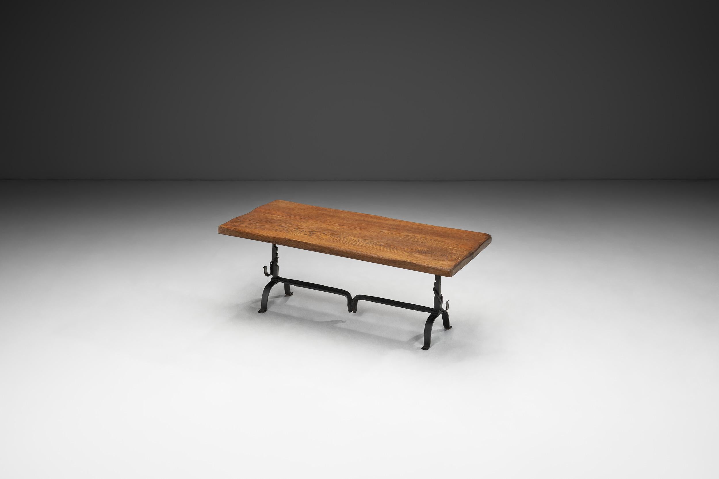 French Oak Table with Iron Base in the manner of Jean Touret, France Mid-20th Century For Sale