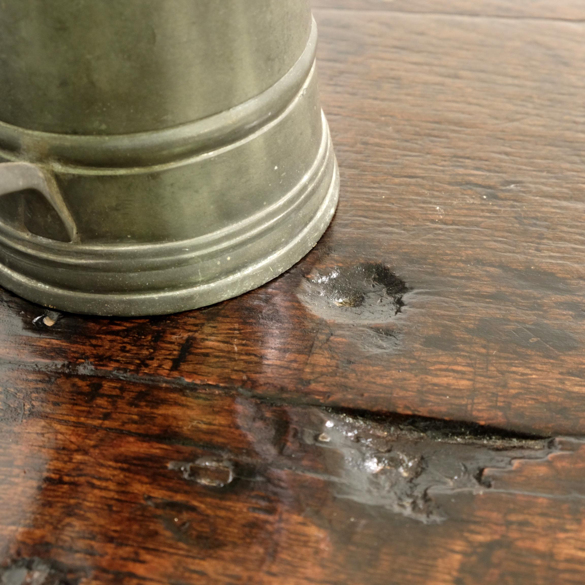 George IV cricket table from an old tavern and bearing the scars of many-a-rowdy night of ale and cards! Wonderful patina with characterful scorch marks to the oak top. The pine base with a useful lower tier, with plenty of the original brown-black