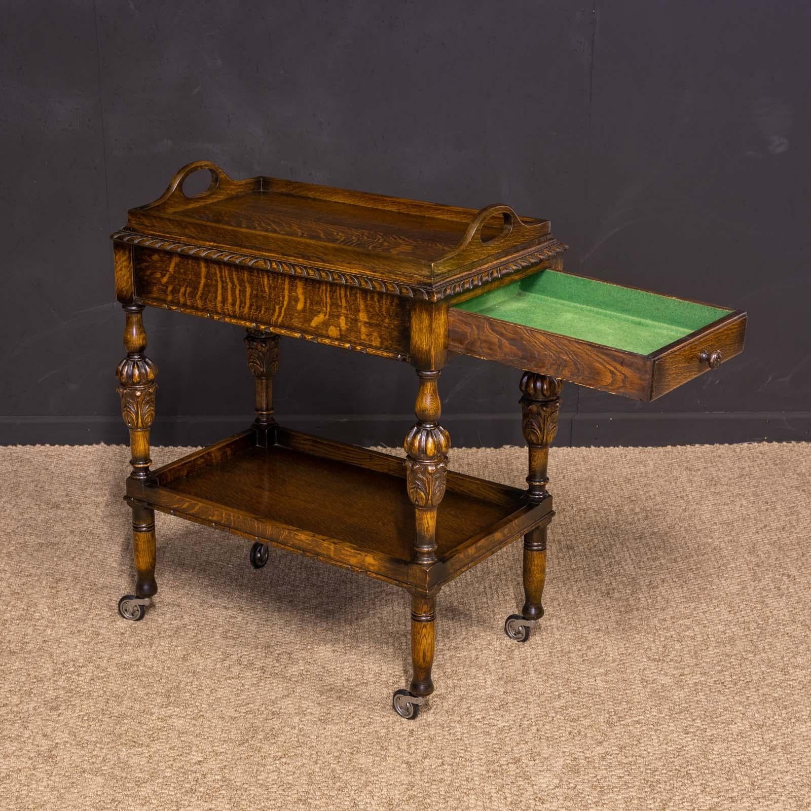 A fantastic oak tea trolley with removable tray top. Certainly one of the best of it's type we have ever seen. With carved baluster legs and a gadrooned edge to the top everything screams quality. To the side there is a cutlery drawer and the whole