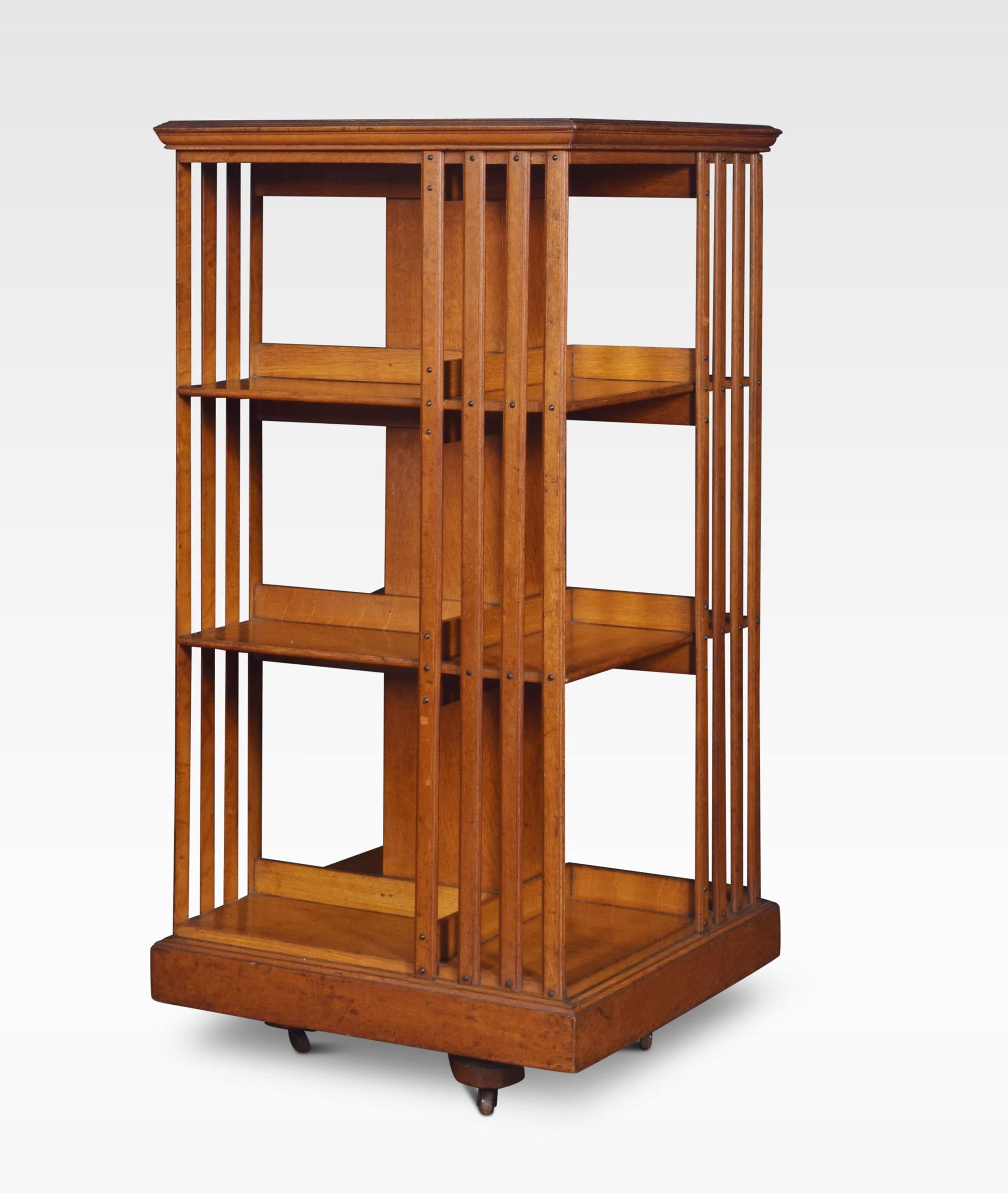 Large oak three-tier revolving bookcase, the square top above an arrangement off graduated shelves raised up on cruciform base with brass caps and ceramic castors.
Dimensions:
Height 46.5 inches
Width 23.5 inches
Depth 23.5 inches.